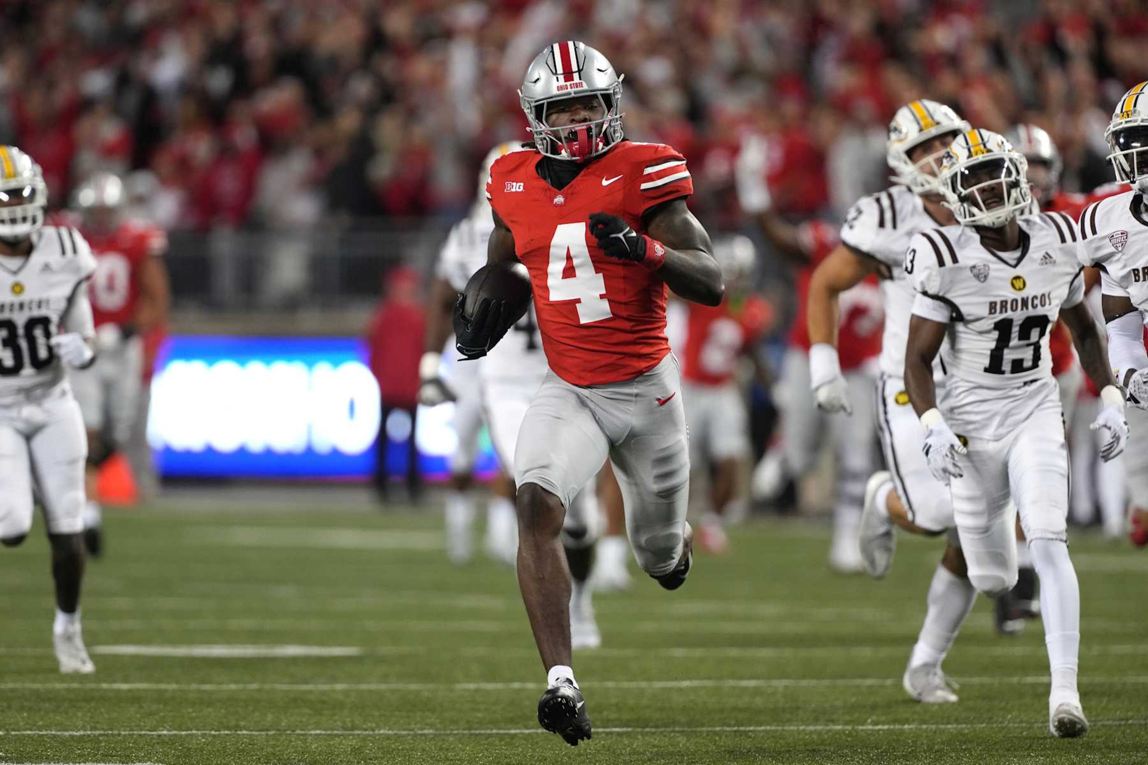 COLUMBUS, OHIO - SEPTEMBER 07: Wide receiver Jeremiah Smith #4 of the Ohio State Buckeyes carries the ball during the first quarter against the Western Michigan Broncos at Ohio Stadium on September 07, 2024 in Columbus, Ohio. (Photo by Jason Mowry/Getty Images) COLUMBUS, OHIO - SEPTEMBER 07: Wide receiver Jeremiah Smith #4 of the Ohio State Buckeyes carries the ball during the first quarter against the Western Michigan Broncos at Ohio Stadium on September 07, 2024 in Columbus, Ohio. (Photo by Jason Mowry/Getty Images)