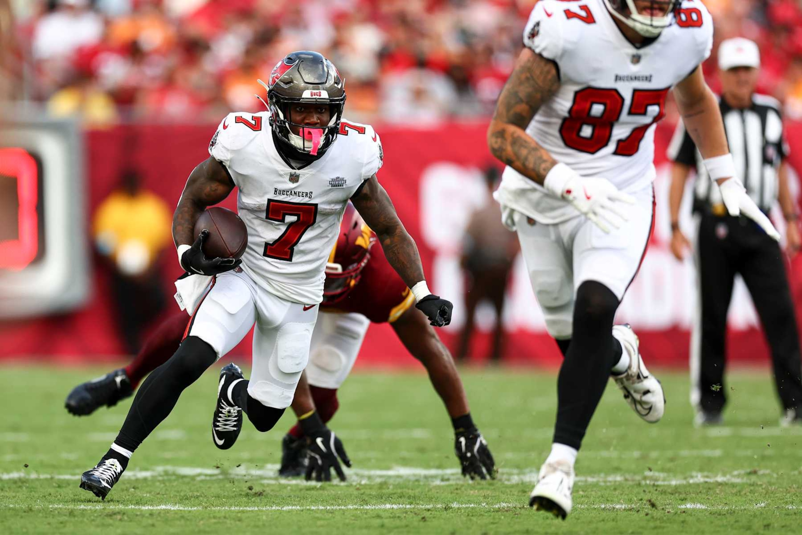 TAMPA, FL - SEPTEMBER 8: Bucky Irving #7 of the Tampa Bay Buccaneers carries the ball during the third quarter of an NFL football game against the Washington Commanders at Raymond James Stadium on September 8, 2024 in Tampa, Florida. (Photo by Kevin Sabitus/Getty Images)