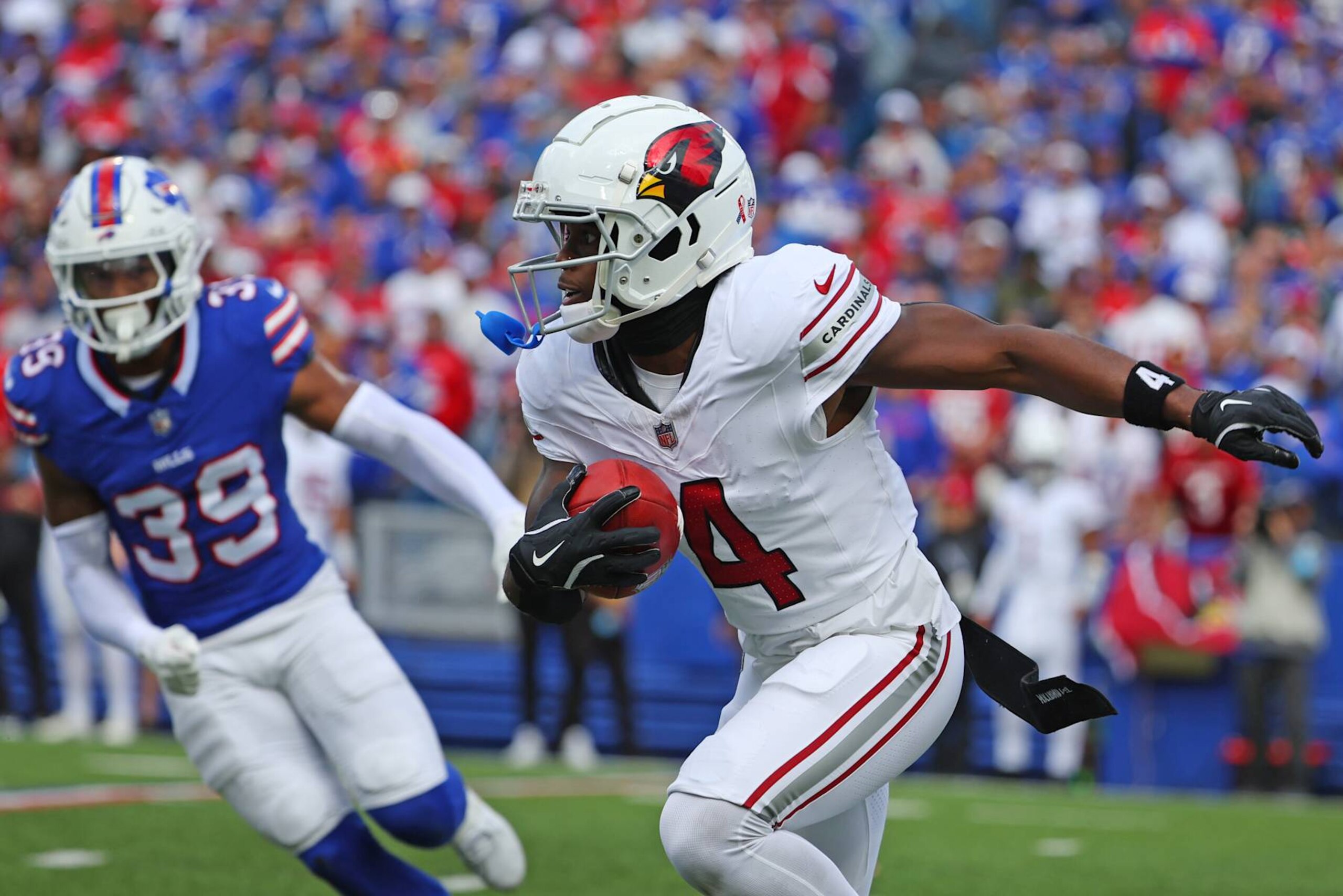 ORCHARD PARK, NEW YORK - SEPTEMBER 08: Greg Dortch #4 of the Arizona Cardinals returns a punt against Cam Lewis #39 of the Buffalo Bills during the third quarter at Highmark Stadium on September 08, 2024 in Orchard Park, New York. (Photo by Timothy T Ludwig/Getty Images)