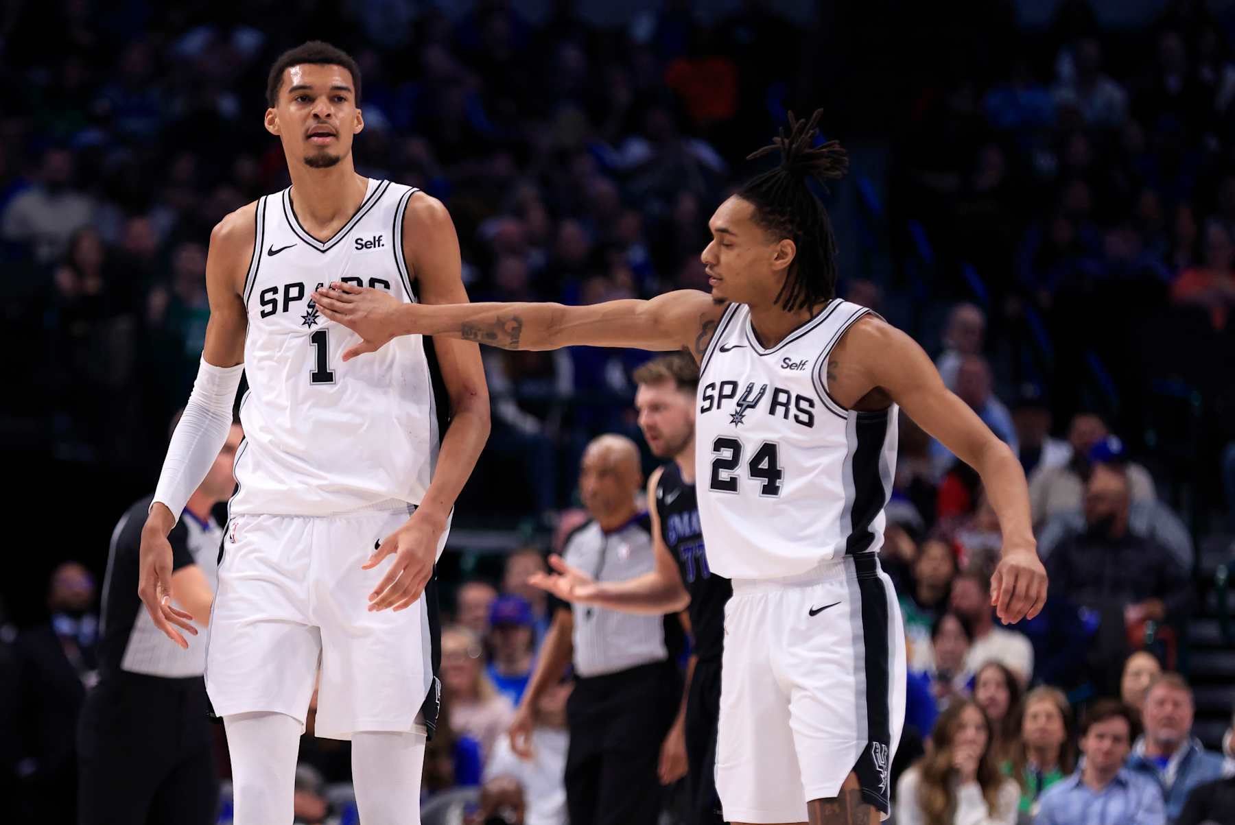 DALLAS, TX - FEBRUARY 14: Victor Wembanyama #1 of the San Antonio Spurs and Devin Vassell #24 of the San Antonio Spurs celebrate a basket against the Dallas Mavericks in the first half at American Airlines Center on February 14, 2024 in Dallas, Texas. NOTE TO USER: User expressly acknowledges and agrees that, by downloading and or using this photograph, User is consenting to the terms and conditions of the Getty Images License Agreement. (Photo by Ron Jenkins/Getty Images)