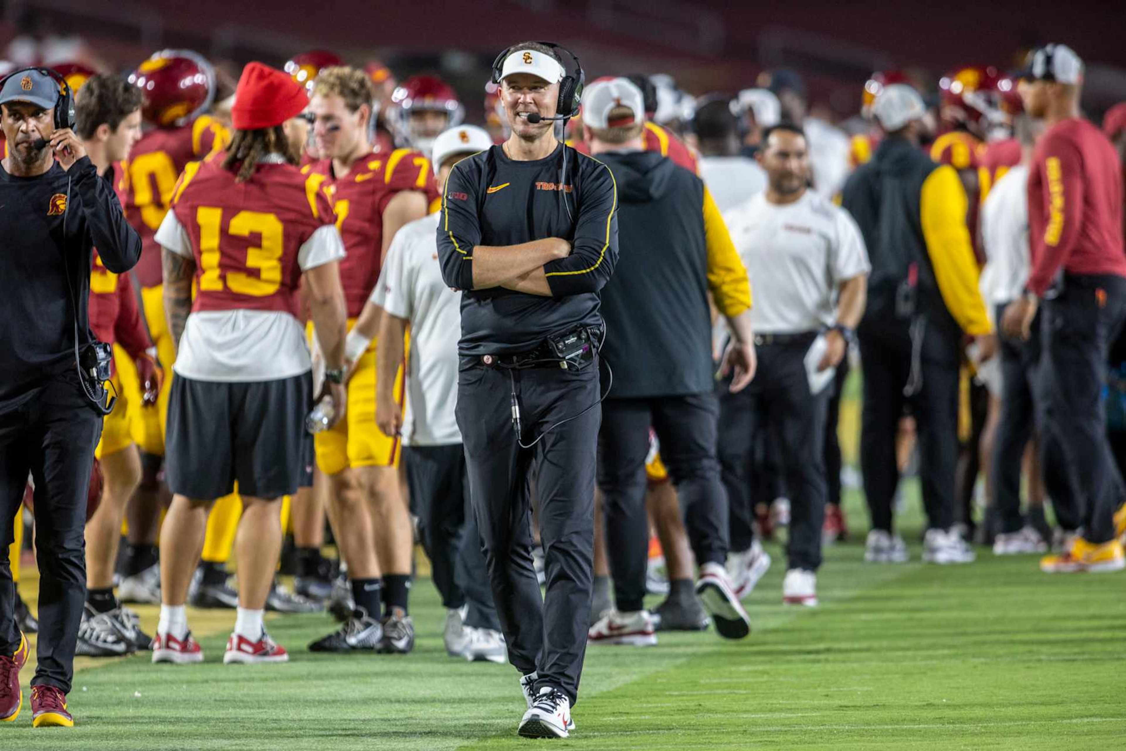 LOS ANGELES, CA - SEPTEMBER 07: USC head coach Lincoln Riley smiles as he walks the sideline and talks into his headset in the second half of a college football game between the Utah State Aggies and the USC Trojans on September 7, 2024, at L.A. Memorial Coliseum in Los Angeles, California. (Photo by Tony Ding/Icon Sportswire via Getty Images) LOS ANGELES, CA - SEPTEMBER 07: USC head coach Lincoln Riley smiles as he walks the sideline and talks into his headset in the second half of a college football game between the Utah State Aggies and the USC Trojans on September 7, 2024, at L.A. Memorial Coliseum in Los Angeles, California. (Photo by Tony Ding/Icon Sportswire via Getty Images)