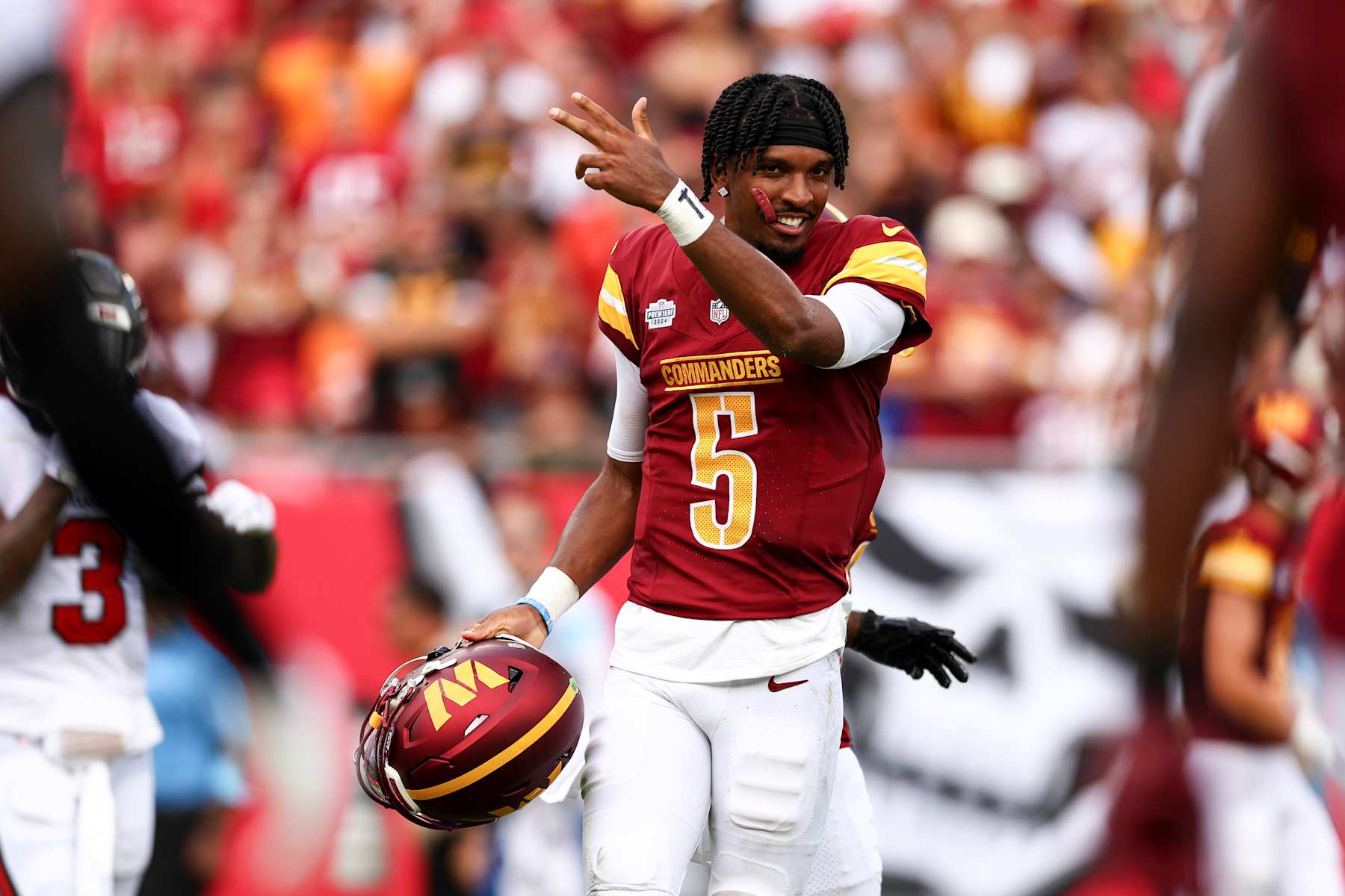 TAMPA, FL - SEPTEMBER 8: Jayden Daniels #5 of the Washington Commanders celebrates after a play during the second quarter of an NFL football game against the Tampa Bay Buccaneers at Raymond James Stadium on September 8, 2024 in Tampa, Florida. (Photo by Kevin Sabitus/Getty Images)