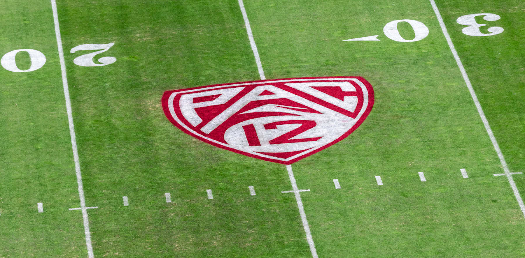 PALO ALTO, CA - NOVEMBER 23:   A detail view of the Pac-12 logo and grass field at Stanford Stadium prior to an NCAA college football game between the Stanford Cardinal and the California Golden Bears in the annual Big Game rivalry on November 23, 2019 in Palo Alto, California.  (Photo by David Madison/Getty Images)