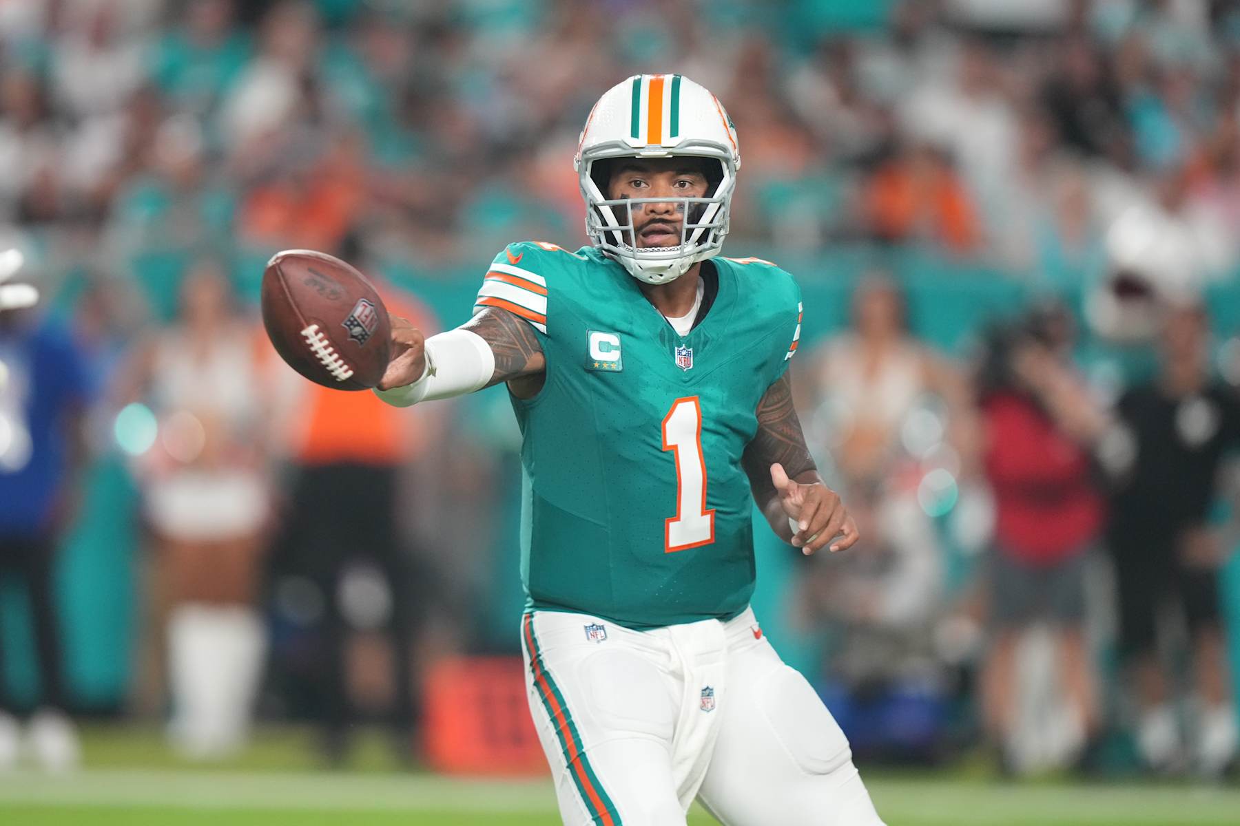 MIAMI GARDENS, FL - SEPTEMBER 12: Miami Dolphins quarterback Tua Tagovailoa (1) makes a no look pitch in the during the game between the Buffalo Bills and the Miami Dolphins on Thursday, September 12, 2024 at Hard Rock Stadium in Miami Gardens, Fla. (Photo by Peter Joneleit/Icon Sportswire via Getty Images)