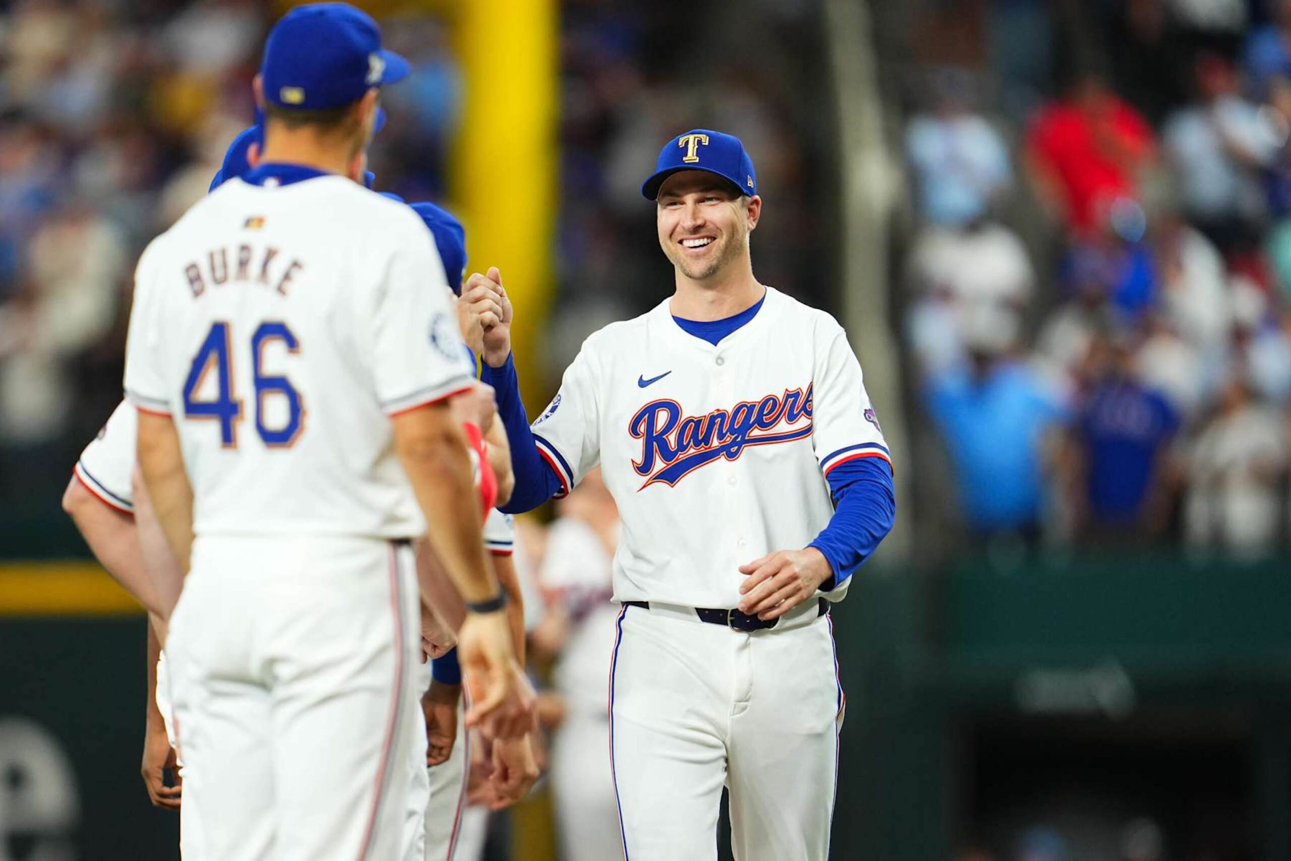 ARLINGTON, TX - MARCH 28:  Jacob deGrom #48 of the Texas Rangers greets teammates on the field prior to the game between the Chicago Cubs and the Texas Rangers at Globe Life Field on Thursday, March 28, 2024 in Arlington, Texas. (Photo by Cooper Neill/MLB Photos via Getty Images)