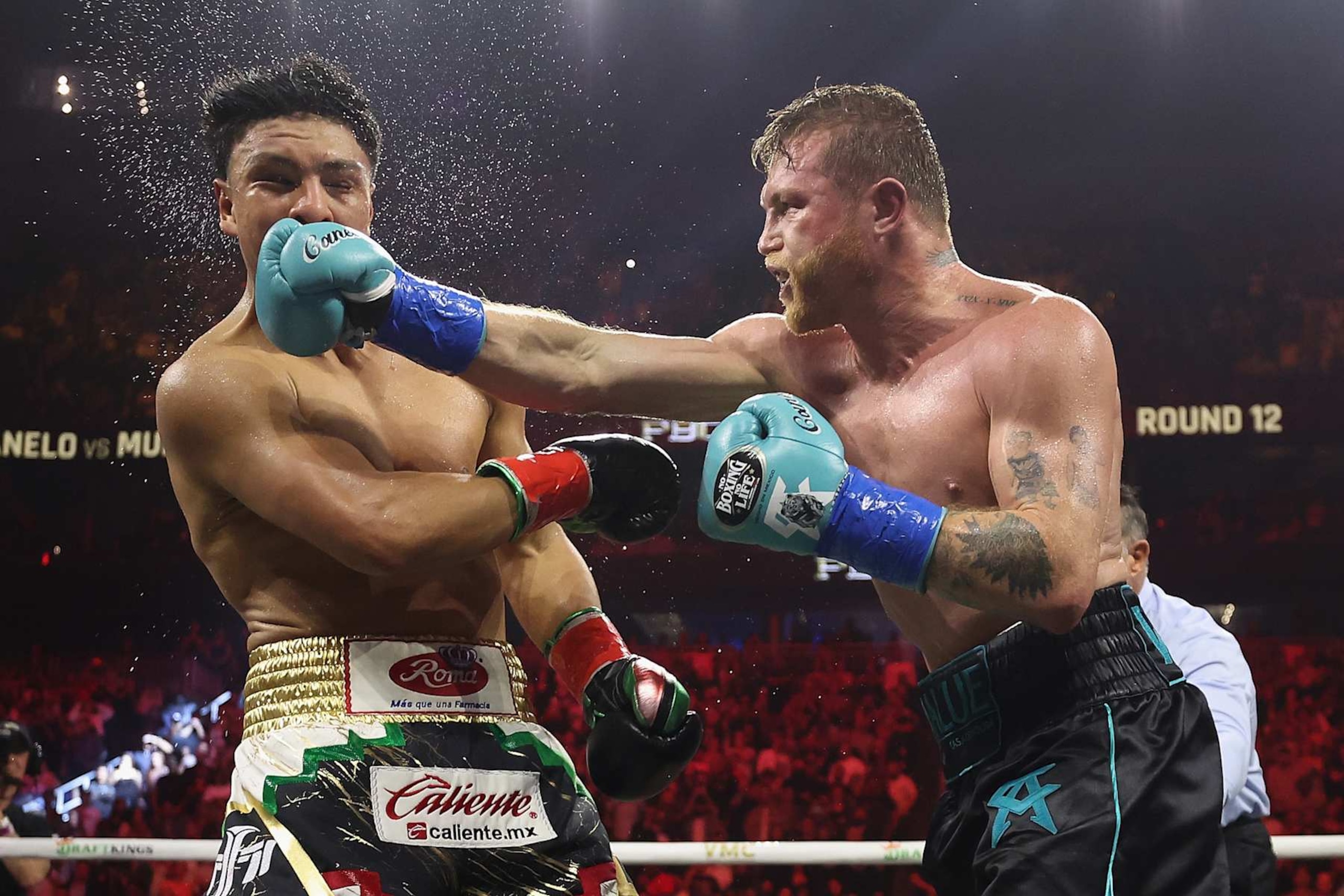 LAS VEGAS, NEVADA - MAY 04: Canelo Alvarez (R) lands a right on Jaime Munguia in the 12th round of their undisputed super middleweight championship fight at T-Mobile Arena on May 04, 2024 in Las Vegas, Nevada. Alvarez retained his titles in a unanimous decision.  (Photo by Christian Petersen/Getty Images)