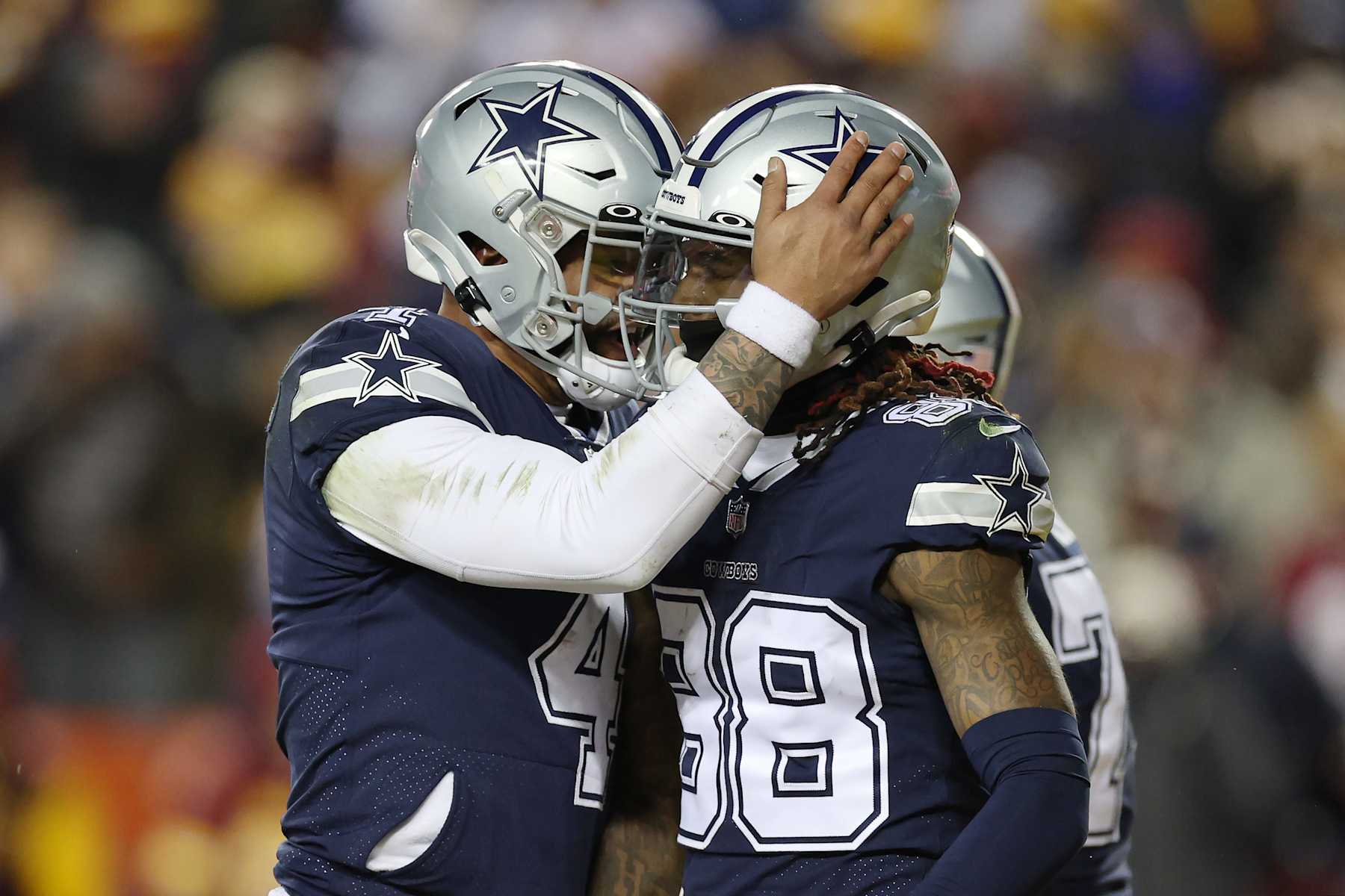 LANDOVER, MARYLAND - JANUARY 08: CeeDee Lamb #88 of the Dallas Cowboys celebrates a touchdown with Dak Prescott #4 of the Dallas Cowboys during the second quarter of the game against the Washington Commanders at FedExField on January 08, 2023 in Landover, Maryland. (Photo by Rob Carr/Getty Images)
