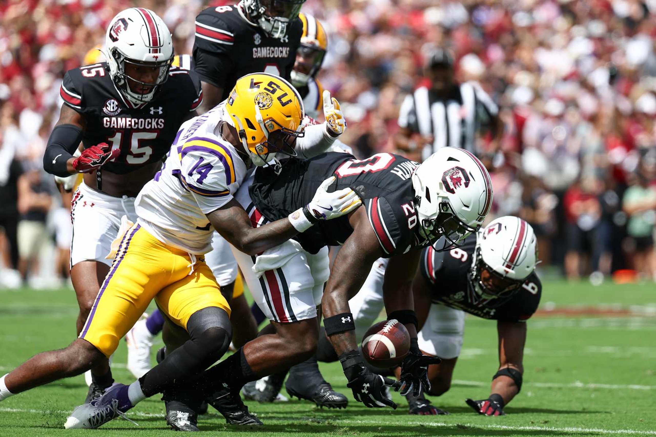 COLUMBIA, SOUTH CAROLINA - SEPTEMBER 14: Michael Smith #20 of the South Carolina Gamecocks and Zy Alexander #14 of the LSU Tigers scramble for a loose ball during the first quarter at Williams-Brice Stadium on September 14, 2024 in Columbia, South Carolina. (Photo by Isaiah Vazquez/Getty Images)