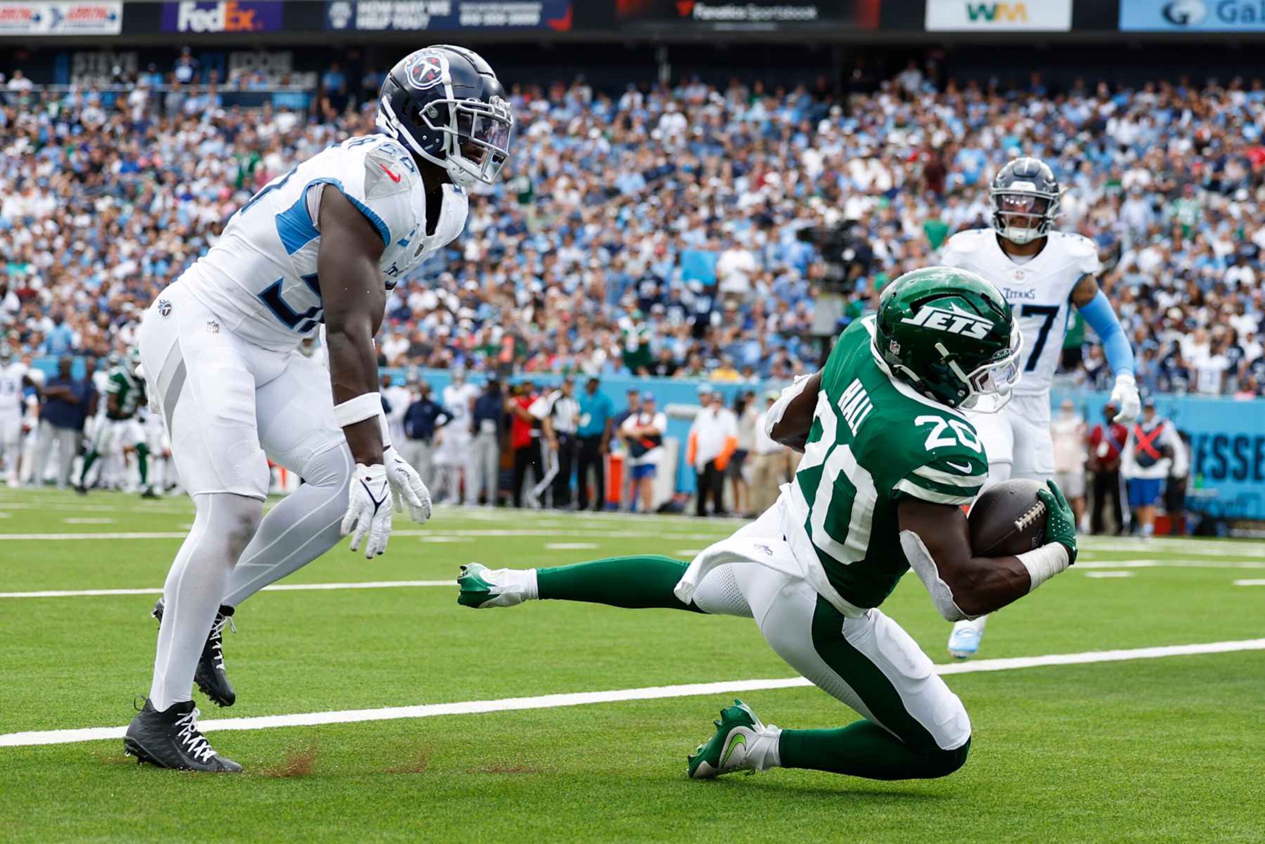 NASHVILLE, TENNESSEE - SEPTEMBER 15: Breece Hall #20 of the New York Jets catches a touchdown pass during the third quarter against the Tennessee Titans at Nissan Stadium on September 15, 2024 in Nashville, Tennessee. (Photo by Wesley Hitt/Getty Images)