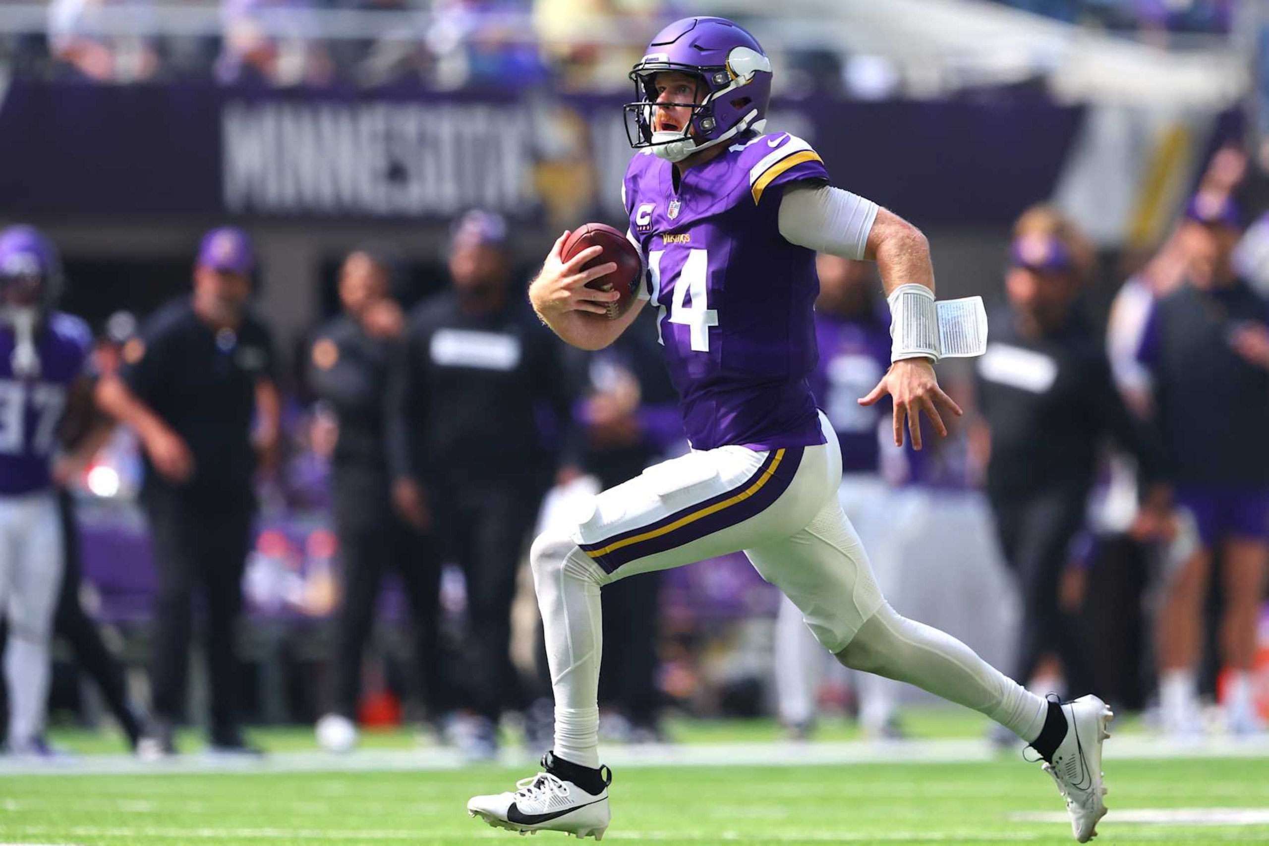 MINNEAPOLIS, MINNESOTA - SEPTEMBER 15: Quarterback Sam Darnold #14 of the Minnesota Vikings runs with the ball against the San Francisco 49ers during the second quarter at U.S. Bank Stadium on September 15, 2024 in Minneapolis, Minnesota. (Photo by Adam Bettcher/Getty Images)