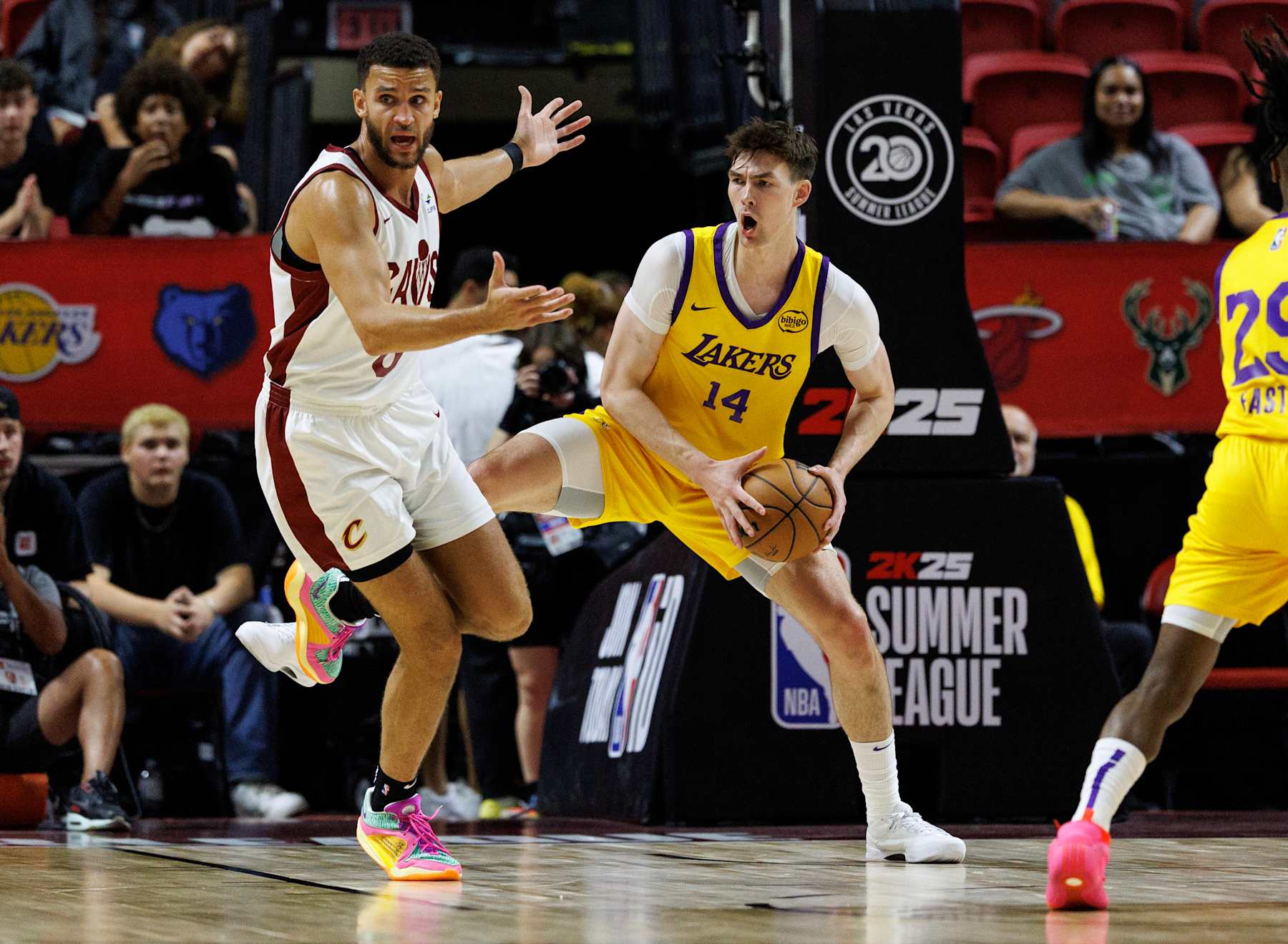 LAS VEGAS, NV - JULY 18, 2024: Los Angeles Lakers center Colin Castleton (14) reacts as he beats Cleveland Cavaliers forward Pete Nance (8) to a defensive rebound during the NBA 2K25 Summer League at the Thomas & Mack Center on July 18, 2024 in Las Vegas, Nevada.(Gina Ferazzi / Los Angeles Times via Getty Images)