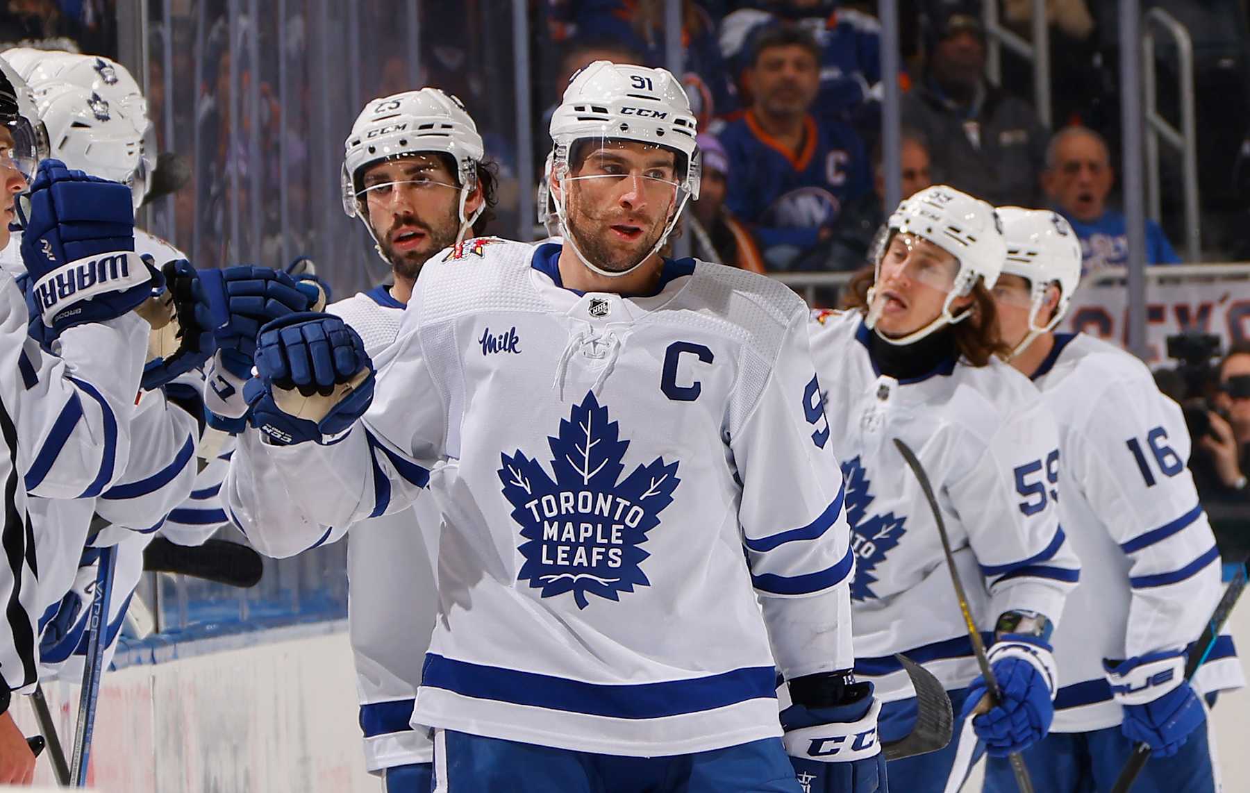 ELMONT, NEW YORK - DECEMBER 11: John Tavares #91 of the Toronto Maple Leafs celebrates his goal at 7:43 of the second period against the New York Islanders at UBS Arena on December 11, 2023 in Elmont, New York. The point was the 999th of his NHL career. (Photo by Bruce Bennett/Getty Images)