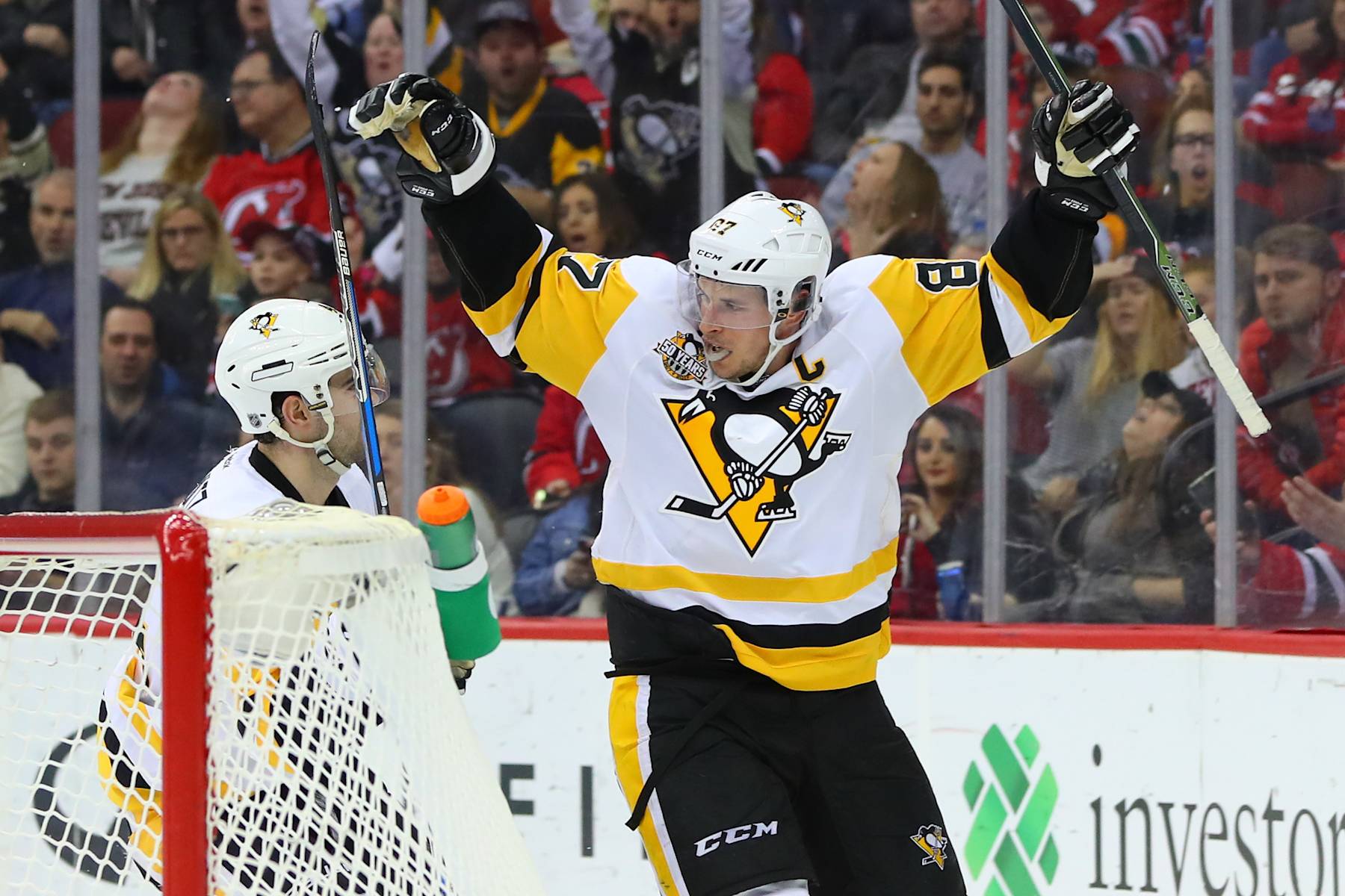 NEWARK, NJ - DECEMBER 27: Pittsburgh Penguins defenseman Justin Schultz (4) celebrates with teammate Pittsburgh Penguins center Sidney Crosby (87) after scoring during the second period of the National Hockey League game between the New Jersey Devils and the Pittsburgh Penguins on December 27, 2016, at the Prudential Center in Newark, NJ. (Photo by Rich Graessle/Icon Sportswire via Getty Images)