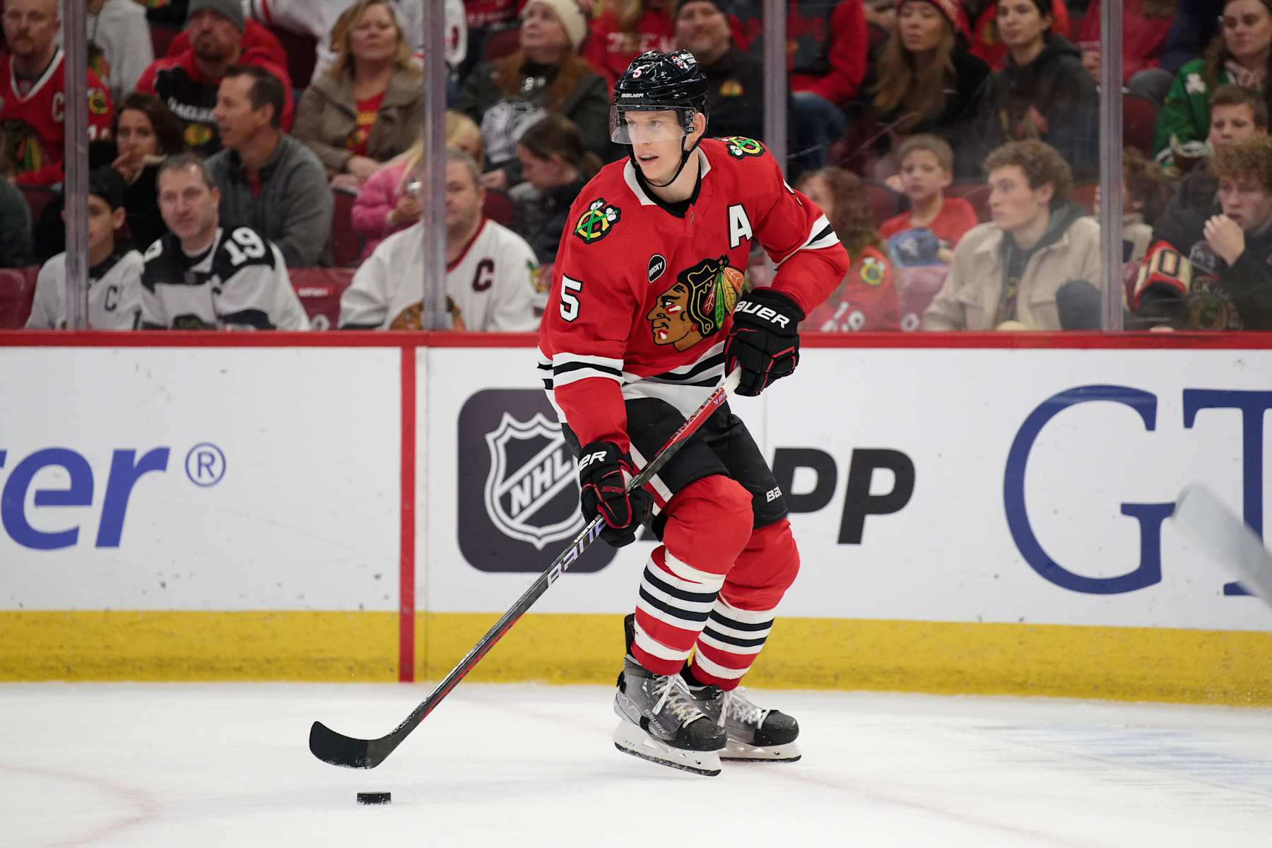 CHICAGO, ILLINOIS - JANUARY 07:  Connor Murphy #5 of the Chicago Blackhawks skates against against the Calgary Flames on January 07, 2024 at United Center in Chicago, Illinois.  (Photo by Jamie Sabau/Getty Images)