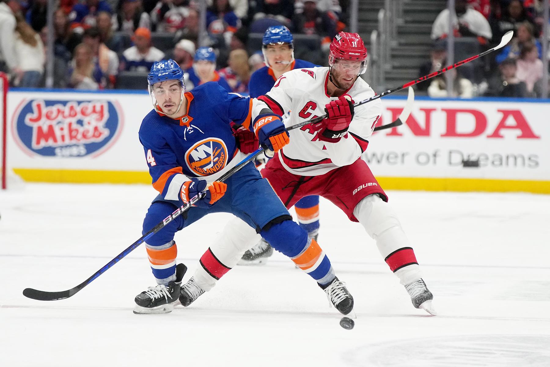 ELMONT, NEW YORK - APRIL 25: Jean-Gabriel Pageau #44 of the New York Islanders and Jordan Staal #11 of the Carolina Hurricanes battle for the puck  in Game Three of the First Round of the 2024 Stanley Cup Playoffs at UBS Arena on April 25, 2024 in Elmont, New York.  (Photo by Mike Stobe/NHLI via Getty Images)