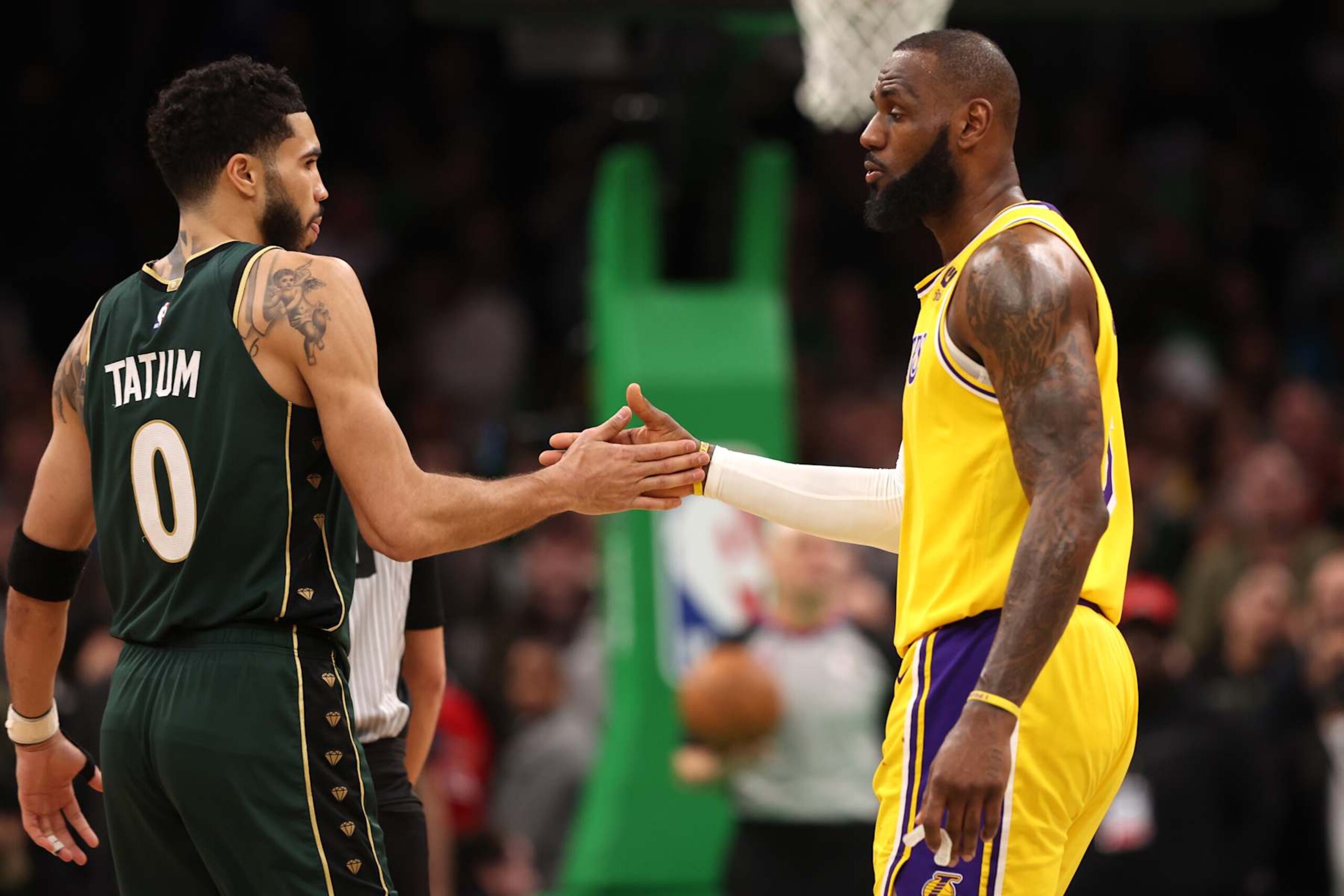 BOSTON, MASSACHUSETTS - JANUARY 28: Jayson Tatum #0 of the Boston Celtics and LeBron James #6 of the Los Angeles Lakers shake hands during overtime at TD Garden on January 28, 2023 in Boston, Massachusetts. The Celtics defeat the Lakers 125-121.  (Photo by Maddie Meyer/Getty Images)