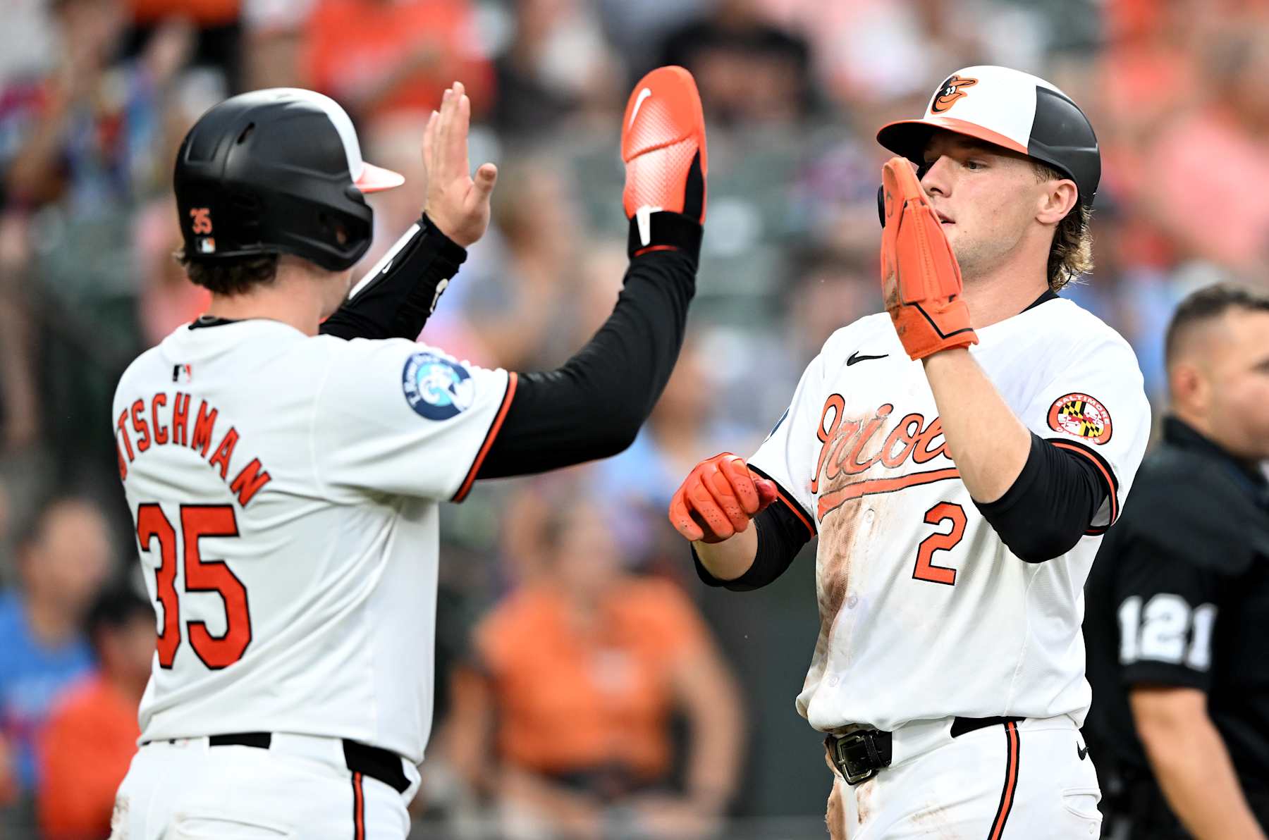 BALTIMORE, MARYLAND - JULY 30: Adley Rutschman #35 and Gunnar Henderson #2 of the Baltimore Orioles celebrate scoring in the third inning against the Toronto Blue Jays at Oriole Park at Camden Yards on July 30, 2024 in Baltimore, Maryland. (Photo by Greg Fiume/Getty Images)