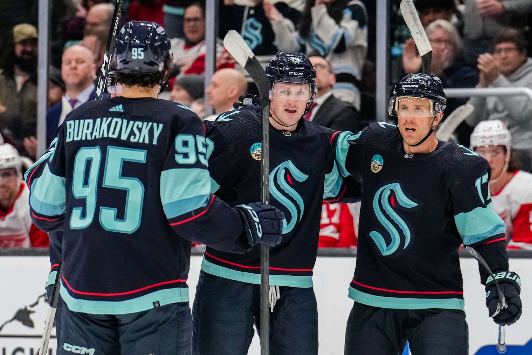 SEATTLE, WASHINGTON - FEBRUARY 19: Jared McCann #19 of the Seattle Kraken celebrates with teammates after scoring a goal during the first period of a game against the Detroit Red Wings at Climate Pledge Arena on February 19, 2024 in Seattle, Washington. (Photo by Christopher Mast/NHLI via Getty Images)