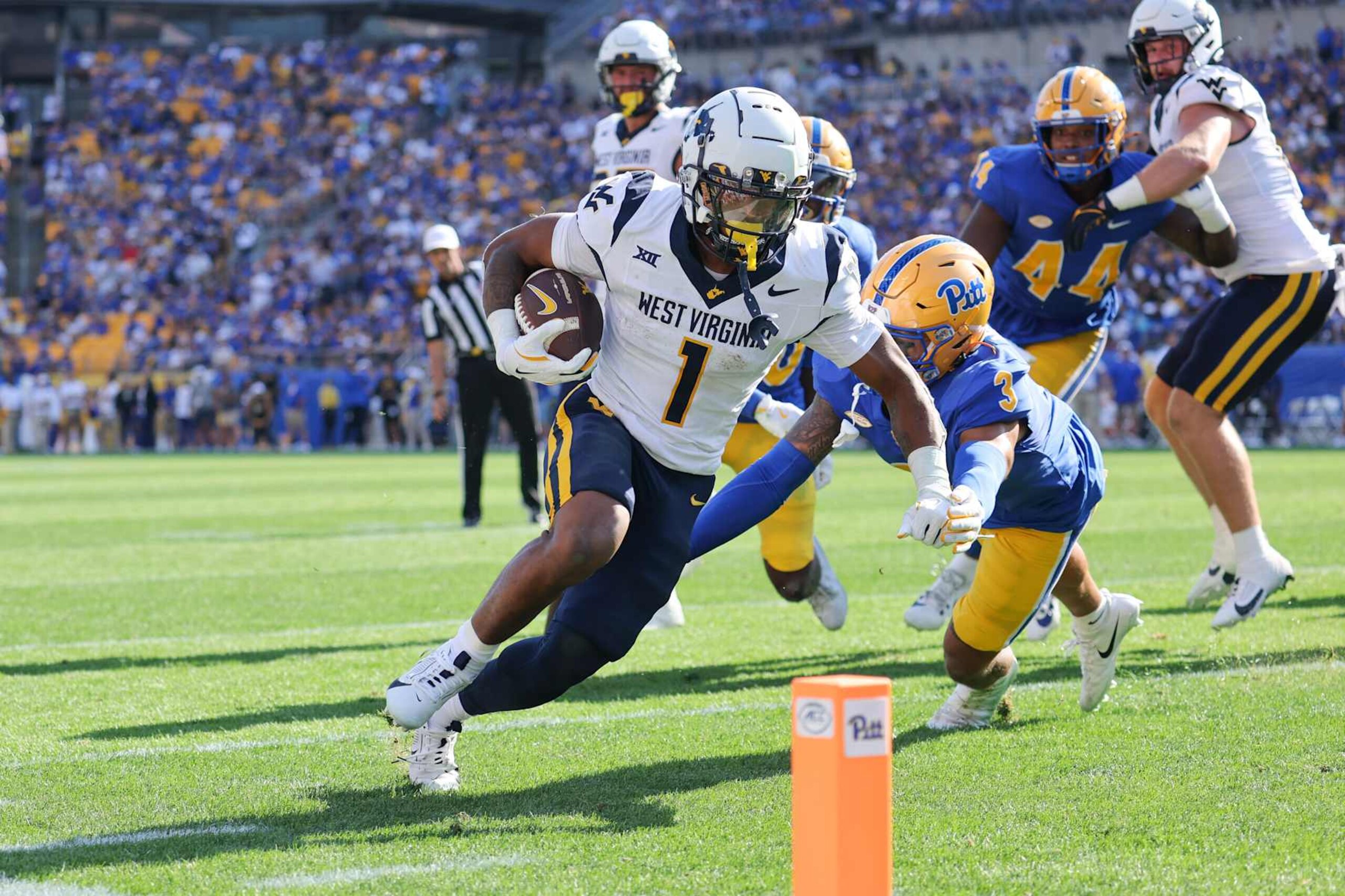 PITTSBURGH, PA - SEPTEMBER 14: West Virginia Mountaineers running back Jahiem White (1) scores on a 5-yard touchdown run during the second quarter of the college football game between the West Virginia Mountaineers and Pitt Panthers on September 14, 2024, at Acrisure Stadium in Pittsburgh, PA. (Photo by Frank Jansky/Icon Sportswire via Getty Images)