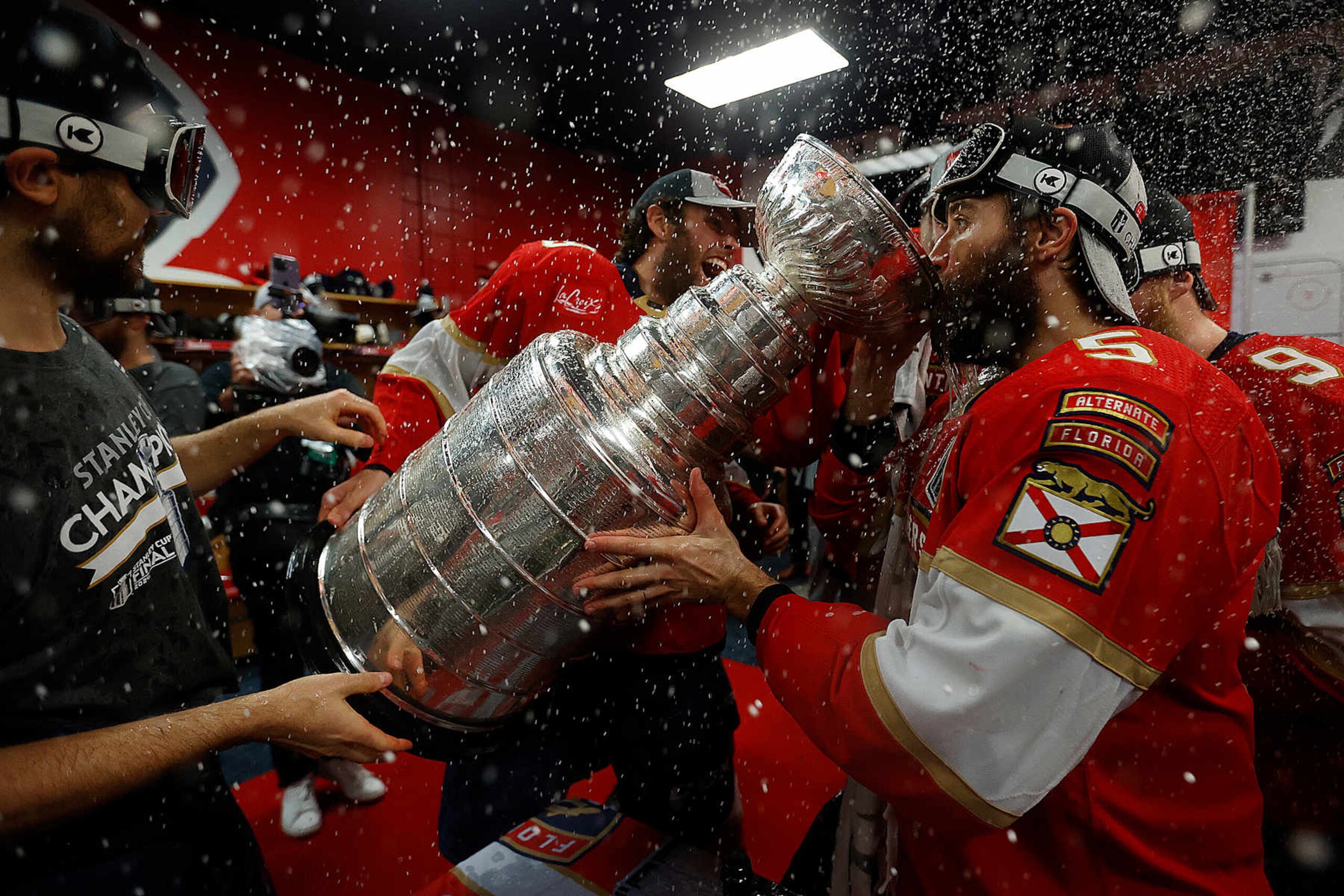 SUNRISE, FLORIDA - JUNE 24: Carter Verhaeghe #23 of the Florida Panthers shares champagne with teammatesAaron Ekblad #5 in the dressing room after beating the Edmonton Oilers in Game Seven of the Stanley Cup Final at the Amerant Bank Arena on June 24, 2024 in Sunrise, Florida. (Photo by Eliot J. Schechter/NHLI via Getty Images) SUNRISE, FLORIDA - JUNE 24: Carter Verhaeghe #23 of the Florida Panthers shares champagne with teammatesAaron Ekblad #5 in the dressing room after beating the Edmonton Oilers in Game Seven of the Stanley Cup Final at the Amerant Bank Arena on June 24, 2024 in Sunrise, Florida. (Photo by Eliot J. Schechter/NHLI via Getty Images)