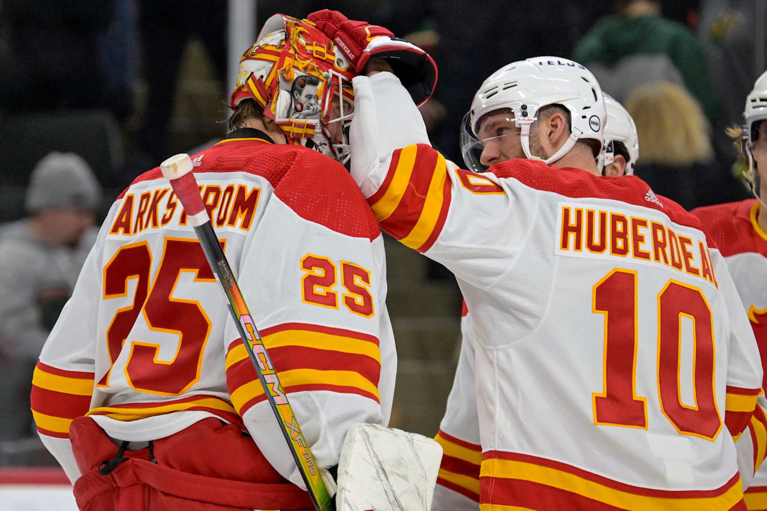 ST. PAUL, MN - JANUARY 02: Calgary Flames Goalie Jacob Markstrom (25) and Calgary Flames Left Wing Jonathan Huberdeau (10) celebrate a win after an NHL game between the Minnesota Wild and Calgary Flames on January 2, 2024, at Xcel Energy Center in St. Paul, MN.(Photo by Nick Wosika/Icon Sportswire via Getty Images) ST. PAUL, MN - JANUARY 02: Calgary Flames Goalie Jacob Markstrom (25) and Calgary Flames Left Wing Jonathan Huberdeau (10) celebrate a win after an NHL game between the Minnesota Wild and Calgary Flames on January 2, 2024, at Xcel Energy Center in St. Paul, MN.(Photo by Nick Wosika/Icon Sportswire via Getty Images)