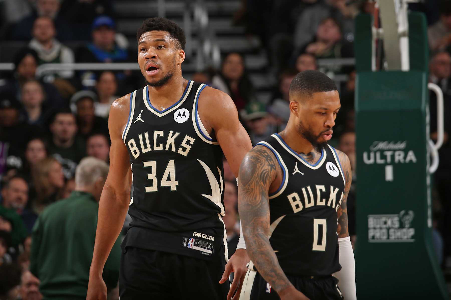 MILWAUKEE, WI - MARCH 14: Giannis Antetokounmpo #34 and Damian Lillard #0 of the Milwaukee Bucks look on during the game against the Philadelphia 76ers on March 14, 2024 at the Fiserv Forum Center in Milwaukee, Wisconsin. NOTE TO USER: User expressly acknowledges and agrees that, by downloading and or using this Photograph, user is consenting to the terms and conditions of the Getty Images License Agreement. Mandatory Copyright Notice: Copyright 2024 NBAE (Photo by Gary Dineen/NBAE via Getty Images).