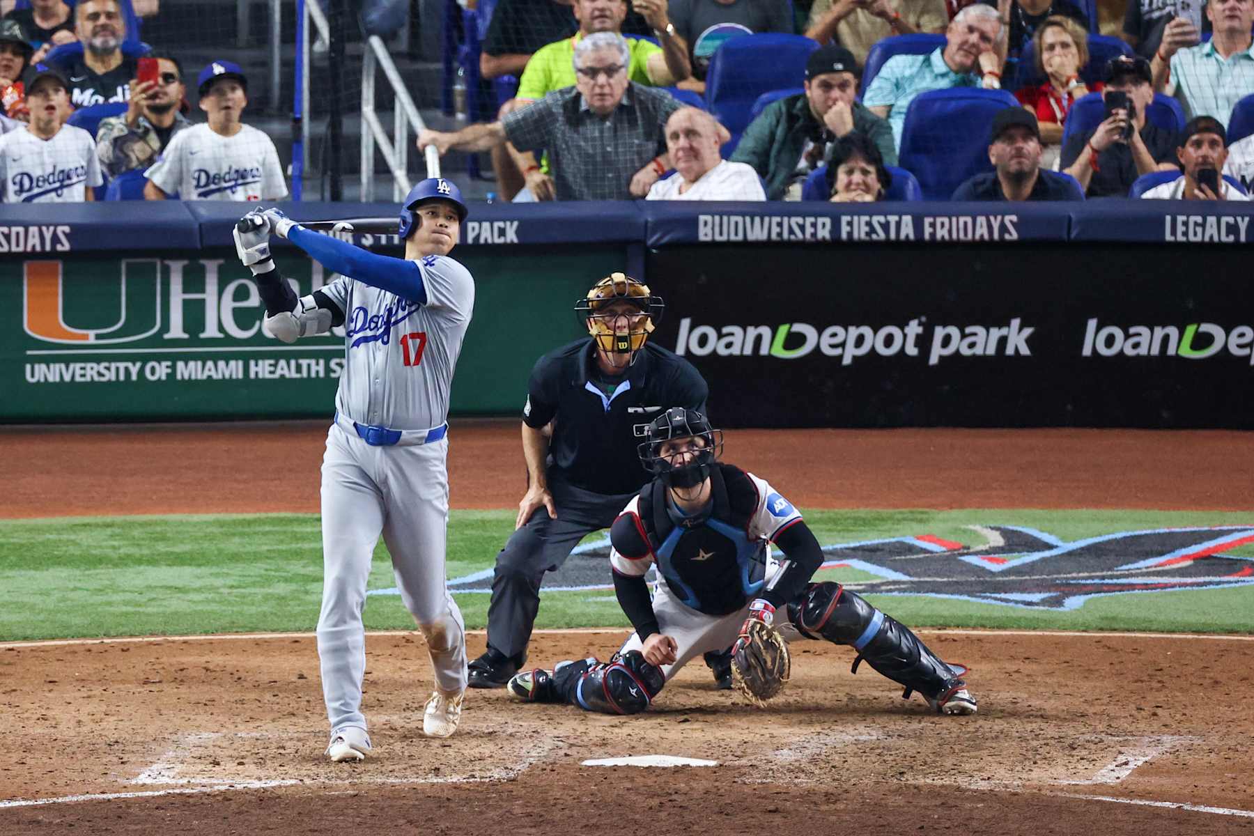 MIAMI, FLORIDA - SEPTEMBER 19: Shohei Ohtani #17 of the Los Angeles Dodgers hits a home run against the Miami Marlins during the seventh inning of the game at loanDepot park on September 19, 2024 in Miami, Florida. Ohtani is now the first MLB player to have at least 50 home runs and 50 stolen bases in the same season. (Photo by Chris Arjoon/Getty Images)