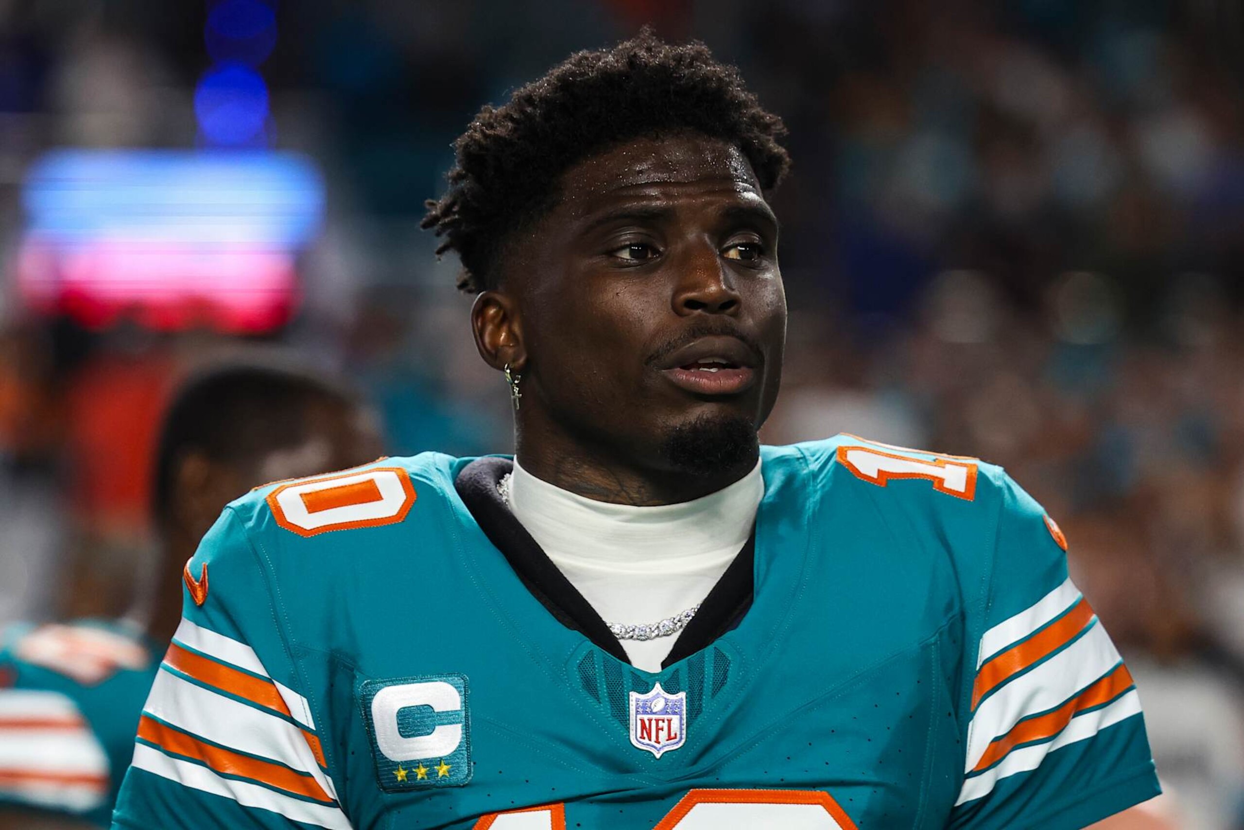 MIAMI GARDENS, FL - SEPTEMBER 12: Tyreek Hill #10 of the Miami Dolphins looks on from the sideline during the national anthem prior to an NFL football game against the Buffalo Bills at Hard Rock Stadium on September 12, 2024 in Miami Gardens, FL. (Photo by Perry Knotts/Getty Images)