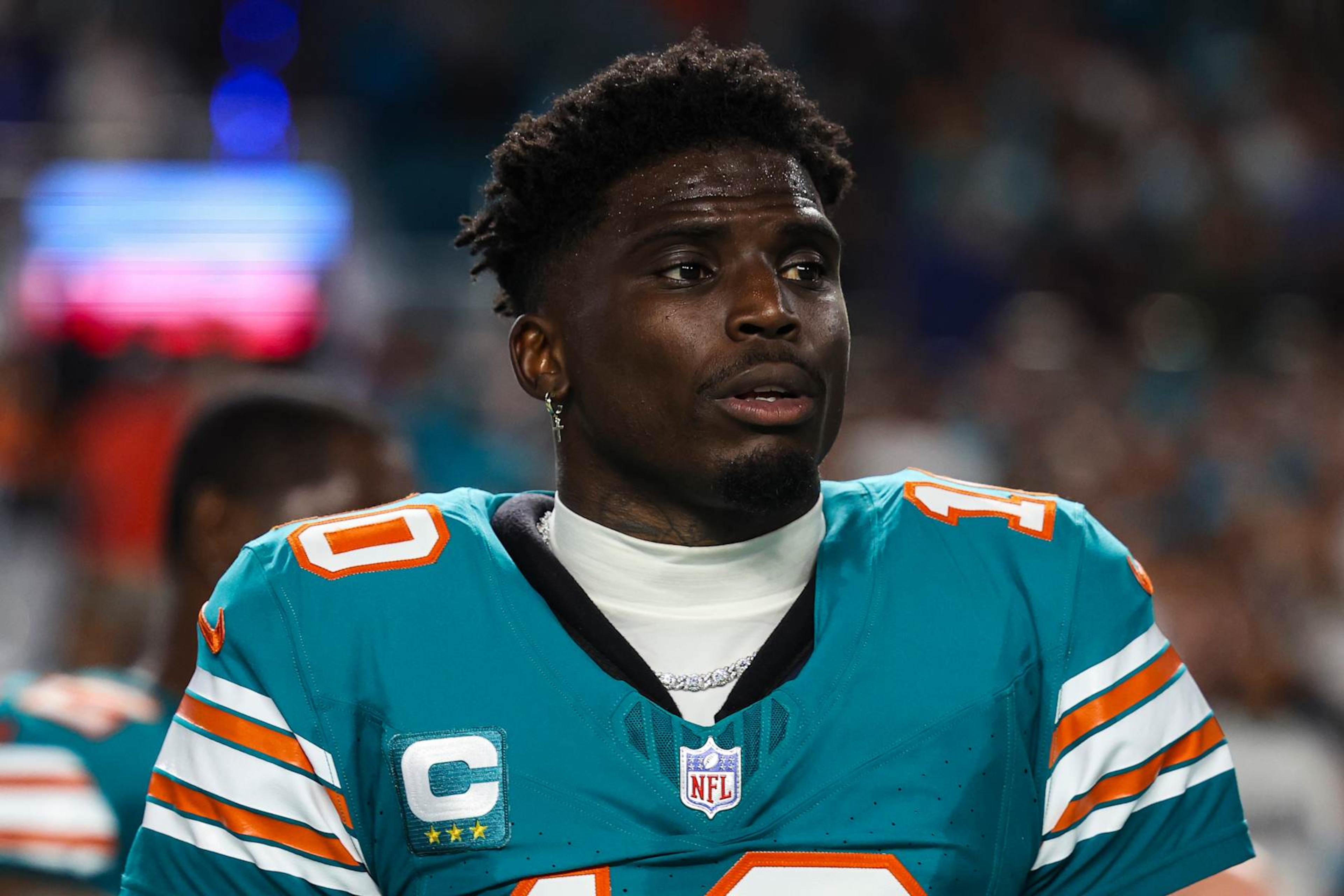 MIAMI GARDENS, FL - SEPTEMBER 12: Tyreek Hill #10 of the Miami Dolphins looks on from the sideline during the national anthem prior to an NFL football game against the Buffalo Bills at Hard Rock Stadium on September 12, 2024 in Miami Gardens, FL. (Photo by Perry Knotts/Getty Images)