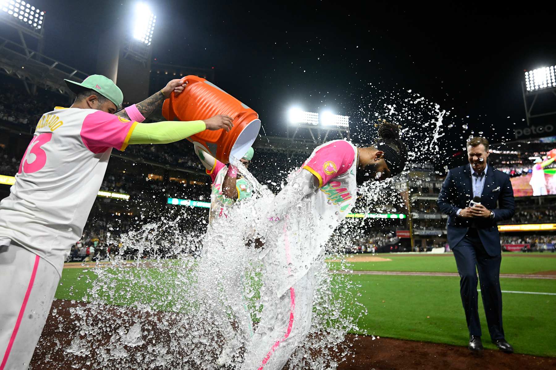 SAN DIEGO, CA - SEPTEMBER 20: Fernando Tatis Jr. (R) #23 of the San Diego Padres has a cooler dumped on him by teammate Manny Machado #13 after he hit a walk-off double during a baseball game against the Chicago White Sox at Petco Park September 20, 2024 in San Diego, California. (Photo by Denis Poroy/Getty Images)