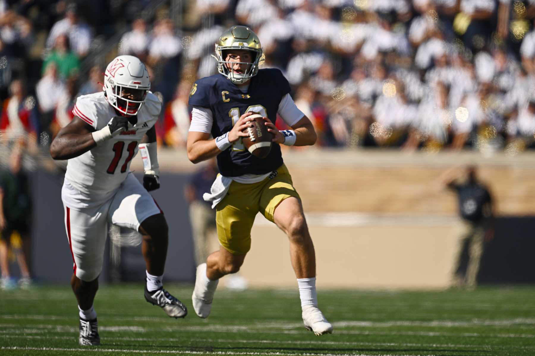 SOUTH BEND, INDIANA - SEPTEMBER 21: Riley Leonard #13 of the Notre Dame Fighting Irish scrambles with the football in the first half against the Miami (OH) Redhawks at Notre Dame Stadium on September 21, 2024 in South Bend, Indiana. (Photo by Quinn Harris/Getty Images)