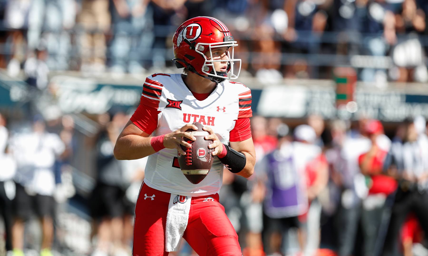 LOGAN, UT - SEPTEMBER 14: Isaac Wilson #11 of the Utah Utes, drops back in the pocket against the Utah State Aggies during the first half of their game at Maverik Stadium on September 14, 2024 in Logan, Utah. (Photo by Chris Gardner/Getty Images)
