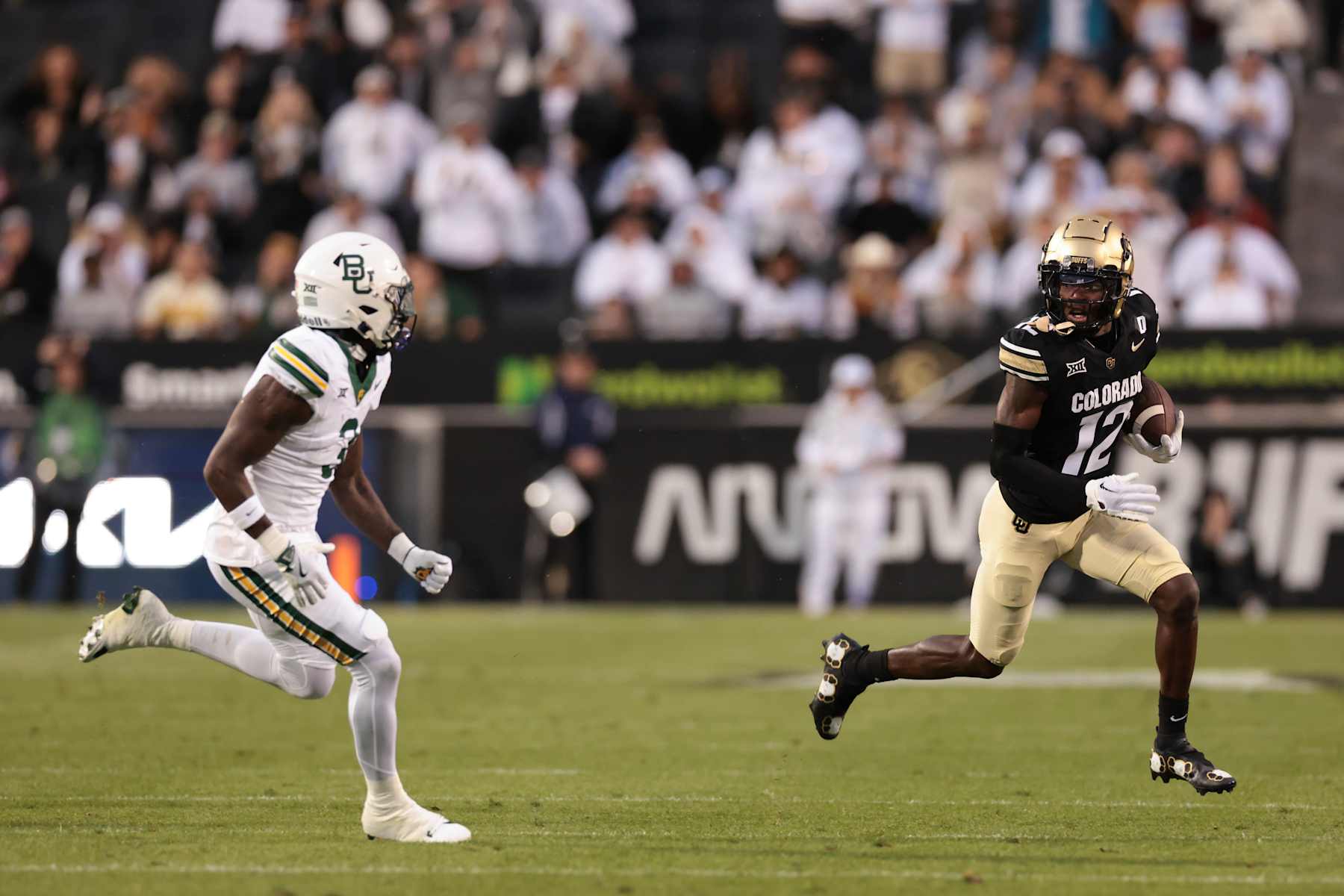 BOULDER, COLORADO - SEPTEMBER 21: Travis Hunter #12 of the Colorado Buffaloes runs with the ball during the first quarter against the Baylor Bears at Folsom Field on September 21, 2024 in Boulder, Colorado. (Photo by Andrew Wevers/Getty Images)