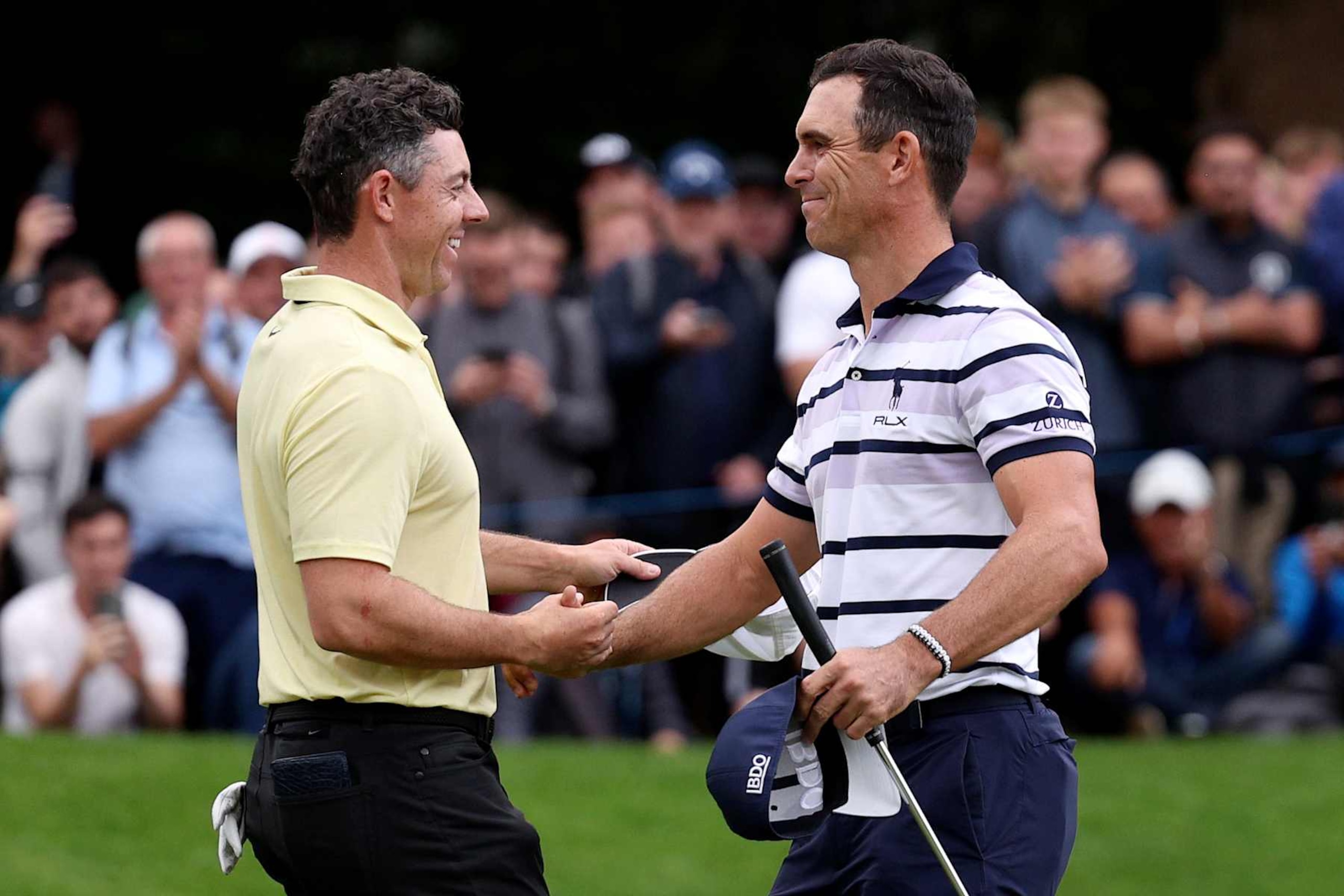 VIRGINIA WATER, ENGLAND - SEPTEMBER 22: Billy Horschel of the United States celebrates on the 18th green with Rory McIlroy of Northern Ireland following victory after the second play-off hole during day four of the BMW PGA Championship 2024 at Wentworth Club on September 22, 2024 in Virginia Water, England. (Photo by Warren Little/Getty Images)