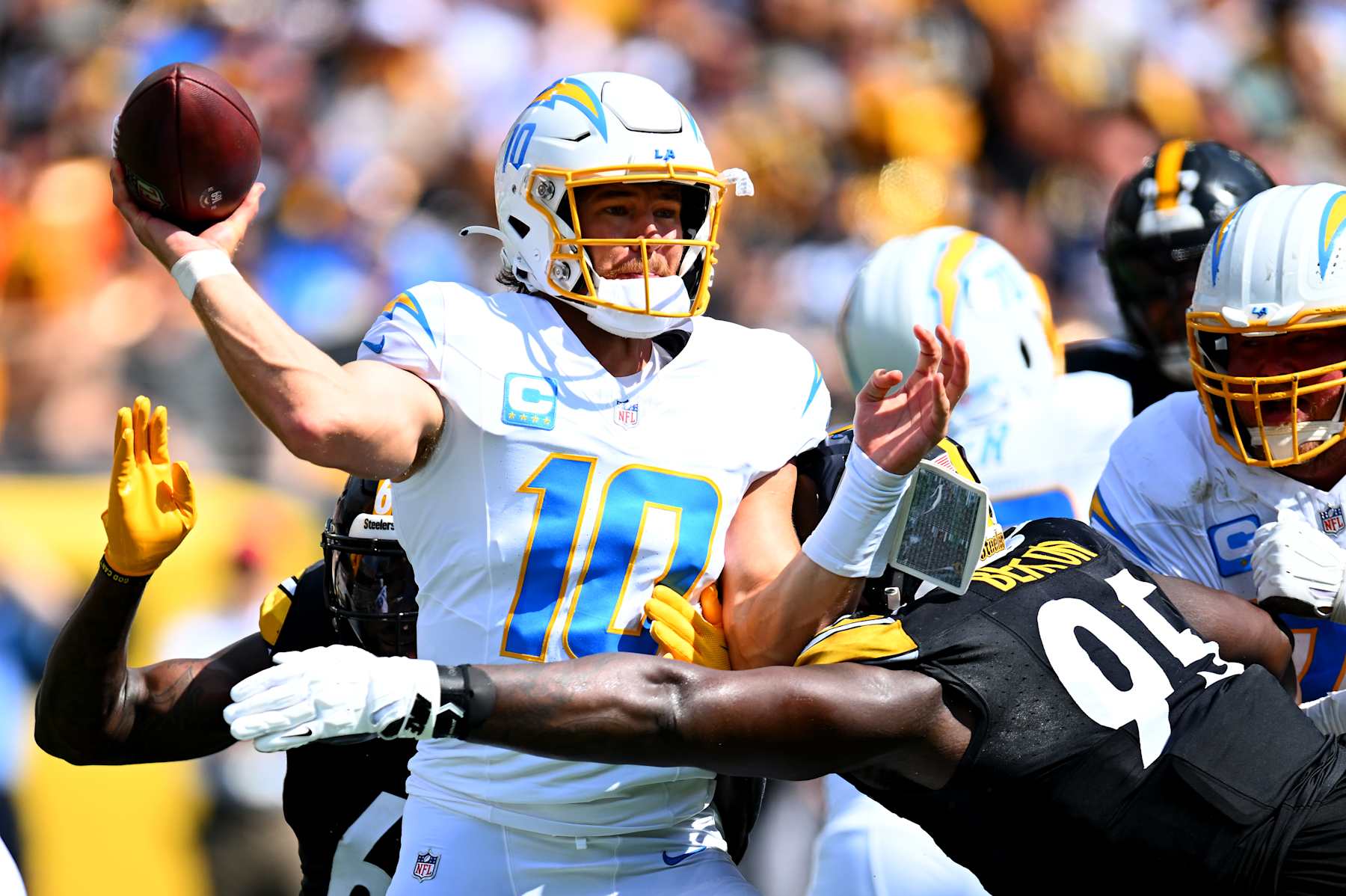 PITTSBURGH, PENNSYLVANIA - SEPTEMBER 22: Quarterback Justin Herbert #10 of the Los Angeles Chargers throws a pass while being pressured by Keeanu Benton #95 of the Pittsburgh Steelers during the first half of the game at Acrisure Stadium on September 22, 2024 in Pittsburgh, Pennsylvania. (Photo by Joe Sargent/Getty Images)