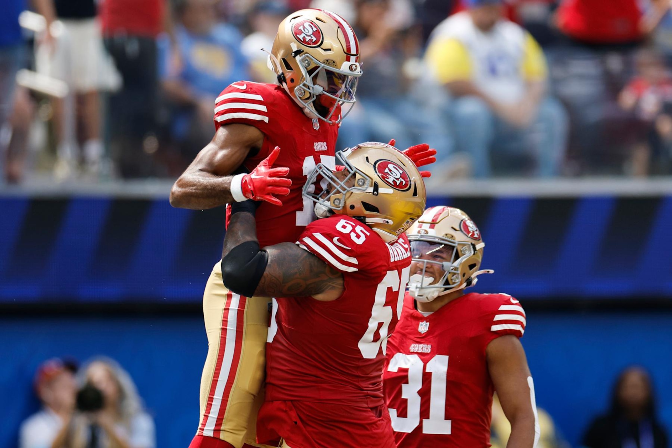 INGLEWOOD, CALIFORNIA - SEPTEMBER 22: Jauan Jennings #15 of the San Francisco 49ers celebrates a touchdown with teammate Aaron Banks #65 of the San Francisco 49ers against the Los Angeles Rams during the first quarter at SoFi Stadium on September 22, 2024 in Inglewood, California. (Photo by Kevork Djansezian/Getty Images)