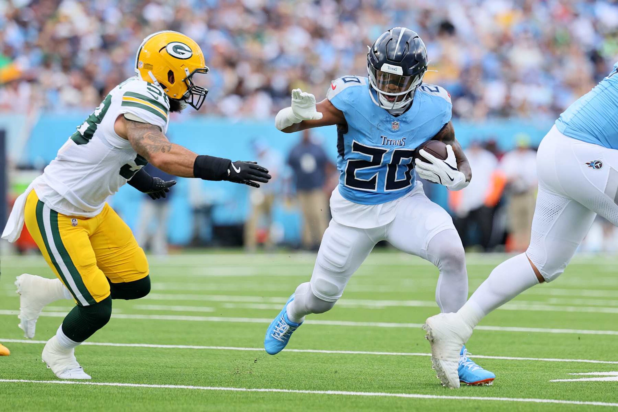 NASHVILLE, TENNESSEE - SEPTEMBER 22: Tony Pollard #20 of the Tennessee Titans rushes against Isaiah McDuffie #58 of the Green Bay Packers during the first quarter at Nissan Stadium on September 22, 2024 in Nashville, Tennessee. (Photo by Andy Lyons/Getty Images)