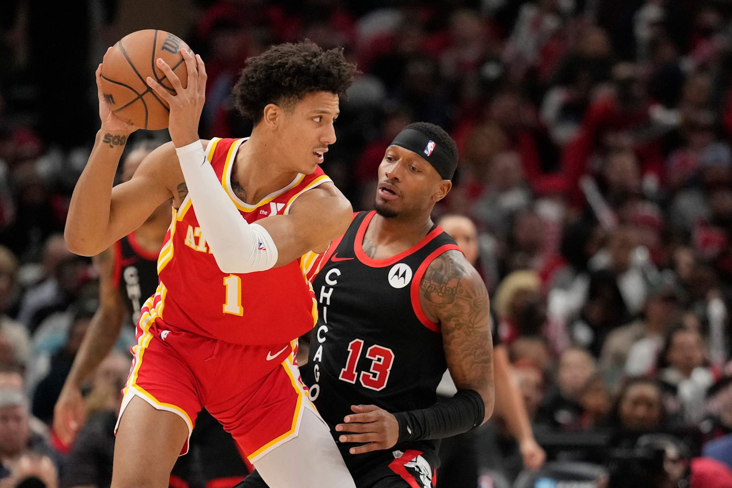 CHICAGO, ILLINOIS - APRIL 01: Jalen Johnson #1 of the Atlanta Hawks handles the ball against Torrey Craig #13 of the Chicago Bulls during the second half at the United Center on April 01, 2024 in Chicago, Illinois. NOTE TO USER: User expressly acknowledges and agrees that, by downloading and or using this photograph, User is consenting to the terms and conditions of the Getty Images License Agreement. (Photo by Patrick McDermott/Getty Images)