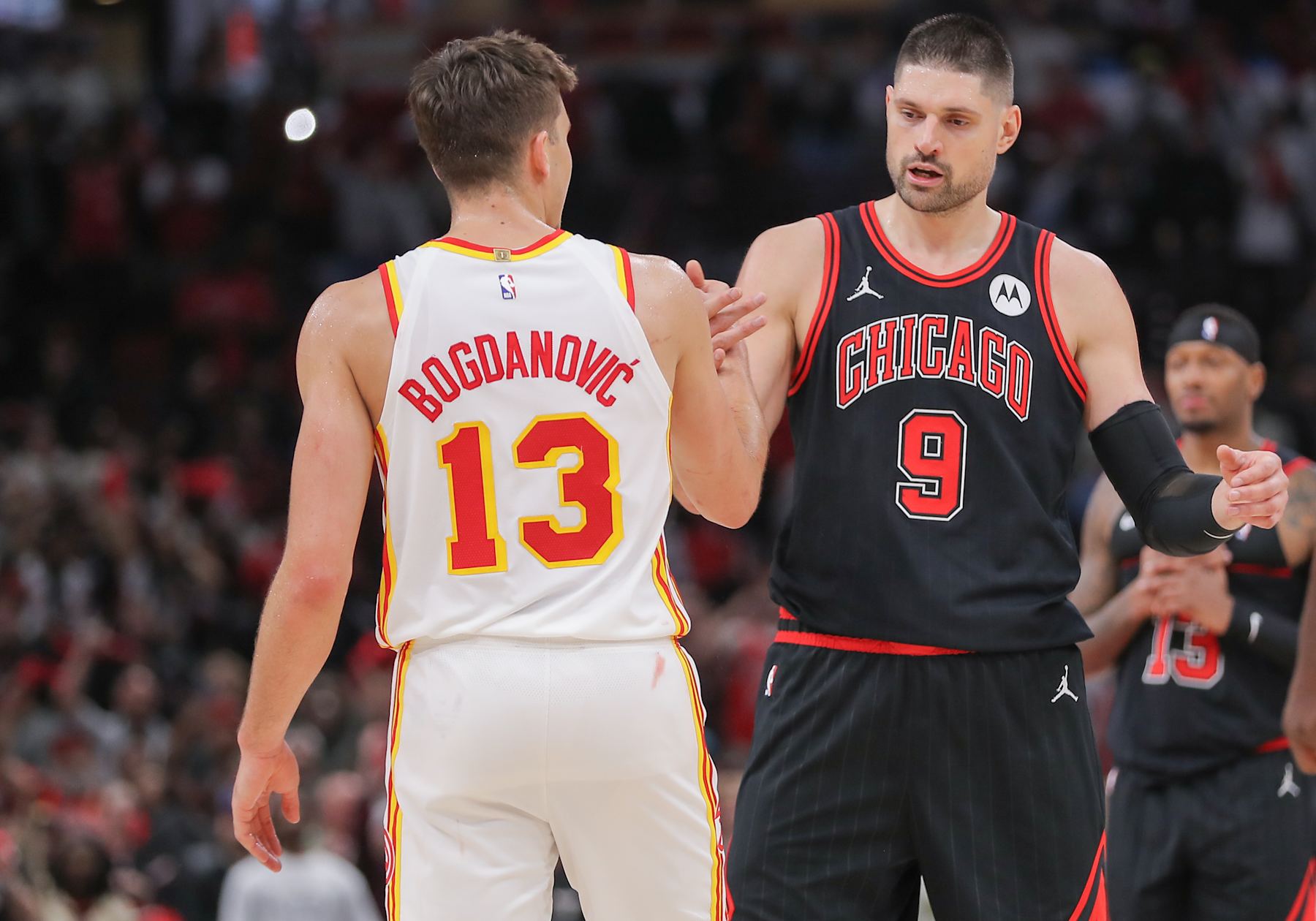 CHICAGO, IL - APRIL 17: Bogdan Bogdanovic #13 of the Atlanta Hawks and Nikola Vucevic #9 of the Chicago Bulls shake hands after the 2024 Play-In Tournament at the United Center on April 17, 2024  in Chicago, Illinois. (Photo by Melissa Tamez/Icon Sportswire via Getty Images)