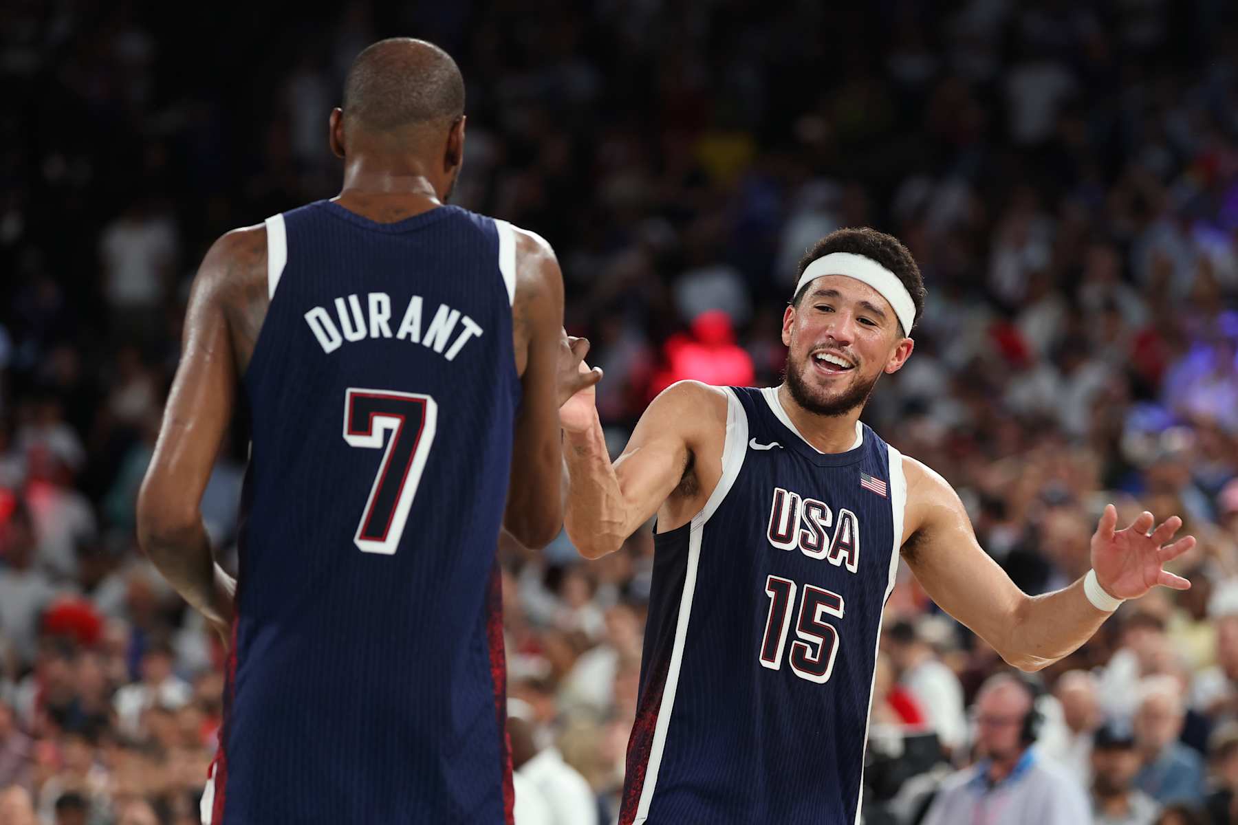 PARIS, FRANCE - AUGUST 10: Kevin Durant #7 and Devin Booker #15 of Team United States celebrate after their victory against Team France during the Men's Gold Medal game between Team France and Team United States on day fifteen of the Olympic Games Paris 2024 at Bercy Arena on August 10, 2024 in Paris, France. (Photo by Gregory Shamus/Getty Images)
