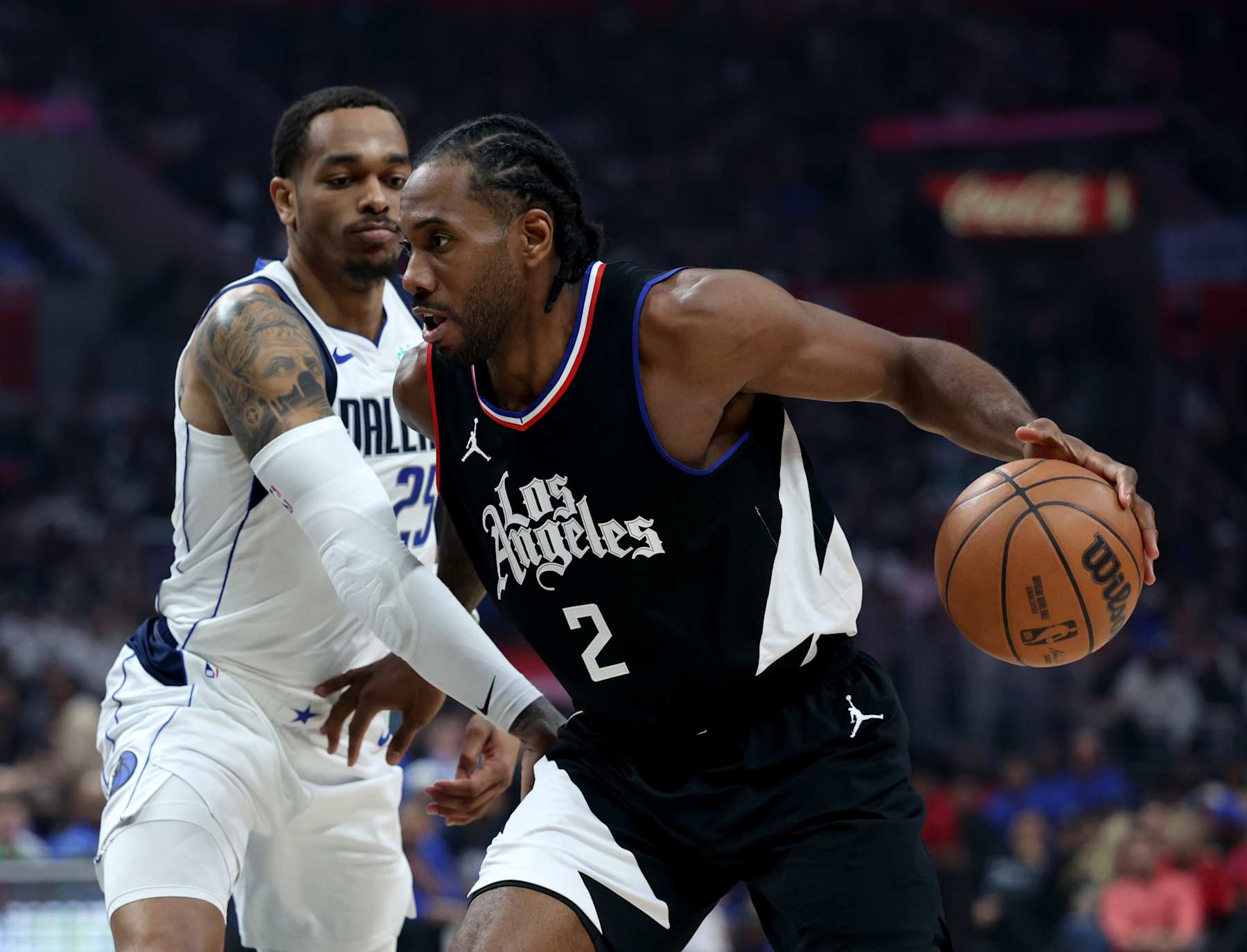 LOS ANGELES, CALIFORNIA - APRIL 23: Kawhi Leonard #2 of the LA Clippers dribbles past P.J. Washington #25 of the Dallas Mavericks during a 96-93 Mavericks win in game two of the Western Conference First Round Playoffs at Crypto.com Arena on April 23, 2024 in Los Angeles, California. User is consenting to the terms and conditions of the Getty Images License Agreement. (Photo by Harry How/Getty Images)