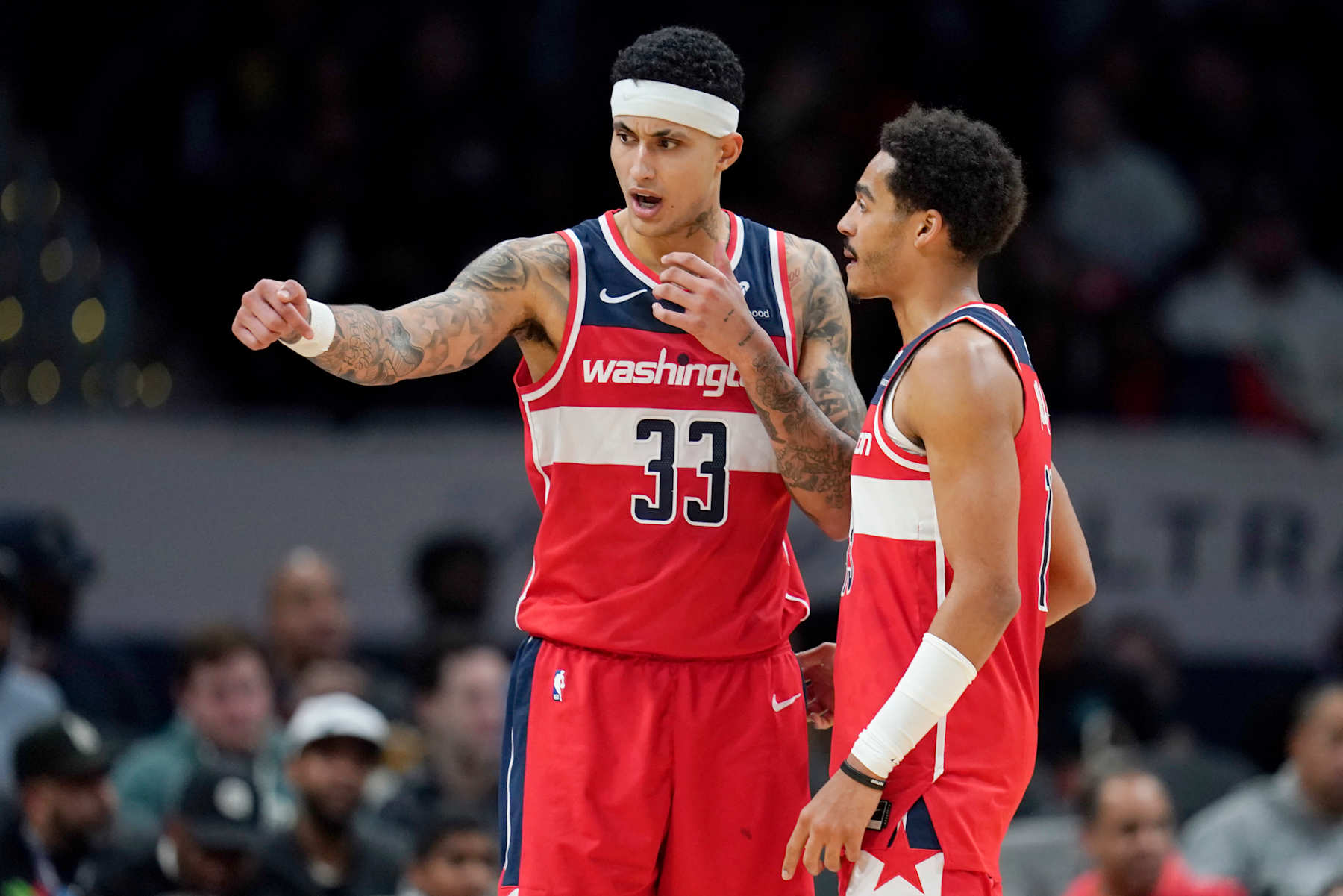 WASHINGTON, DC - DECEMBER 29: Kyle Kuzma #33 of the Washington Wizards and Jordan Poole #13 talk on the court during the second half against the Brooklyn Nets at Capital One Arena on December 29, 2023 in Washington, DC. NOTE TO USER: User expressly acknowledges and agrees that, by downloading and or using this photograph, User is consenting to the terms and conditions of the Getty Images License Agreement. (Photo by Jess Rapfogel/Getty Images)