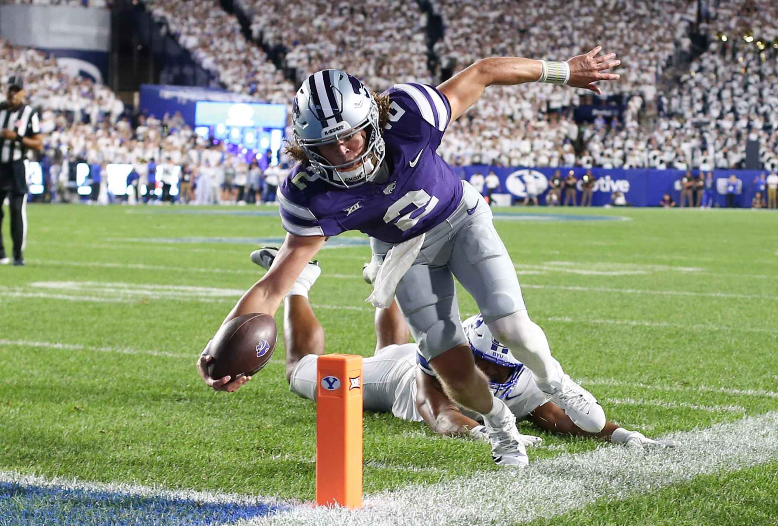 PROVO, UT - SEPTEMBER 21: Avery Johnson #2 of the Kansas State Wildcats scores a touchdown agisnt Aisea Moa #58 of the Brigham Young Cougars during the second half of their game at LaVell Edwards Stadium on September 21, 2024 in Provo, Utah.(Photo by Chris Gardner/Getty Images)