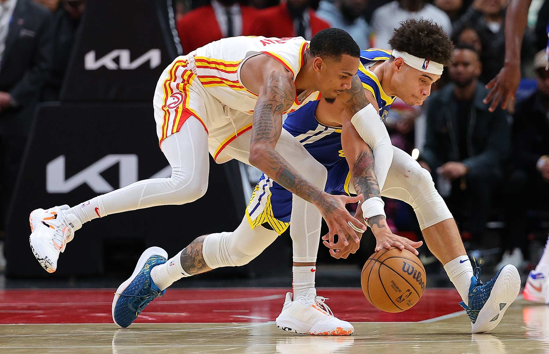 ATLANTA, GEORGIA - FEBRUARY 03:  Lester Quinones #25 of the Golden State Warriors draws a foul as he steals the ball from Dejounte Murray #5 of the Atlanta Hawks during overtime at State Farm Arena on February 03, 2024 in Atlanta, Georgia.  NOTE TO USER: User expressly acknowledges and agrees that, by downloading and/or using this photograph, user is consenting to the terms and conditions of the Getty Images License Agreement.  (Photo by Kevin C. Cox/Getty Images)