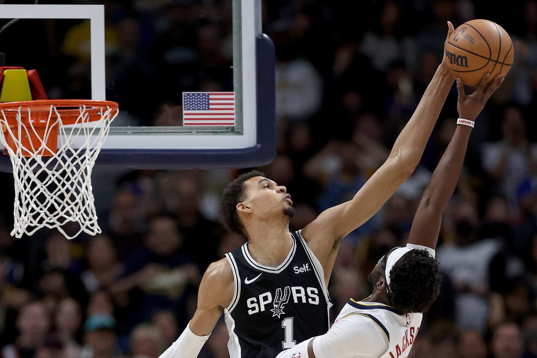 DENVER, COLORADO - APRIL 02: Victor Wembanyama #1 of the San Antonio Spurs blocks a shot by Reggie Jackson #7 of the Denver Nuggets during the fourth quarter at Ball Arena on April 02, 2024 in Denver, Colorado. NOTE TO USER: User expressly acknowledges and agrees that, by downloading and or using this photograph, User is consenting to the terms and conditions of the Getty Images License Agreement.   (Photo by Matthew Stockman/Getty Images)