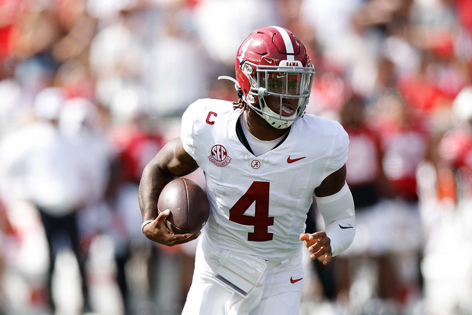 MADISON, WISCONSIN - SEPTEMBER 14: Jalen Milroe #4 of the Alabama Crimson Tide runs with the football during the game against the Wisconsin Badgers at Camp Randall Stadium on September 14, 2024 in Madison, Wisconsin. (Photo by John Fisher/Getty Images)