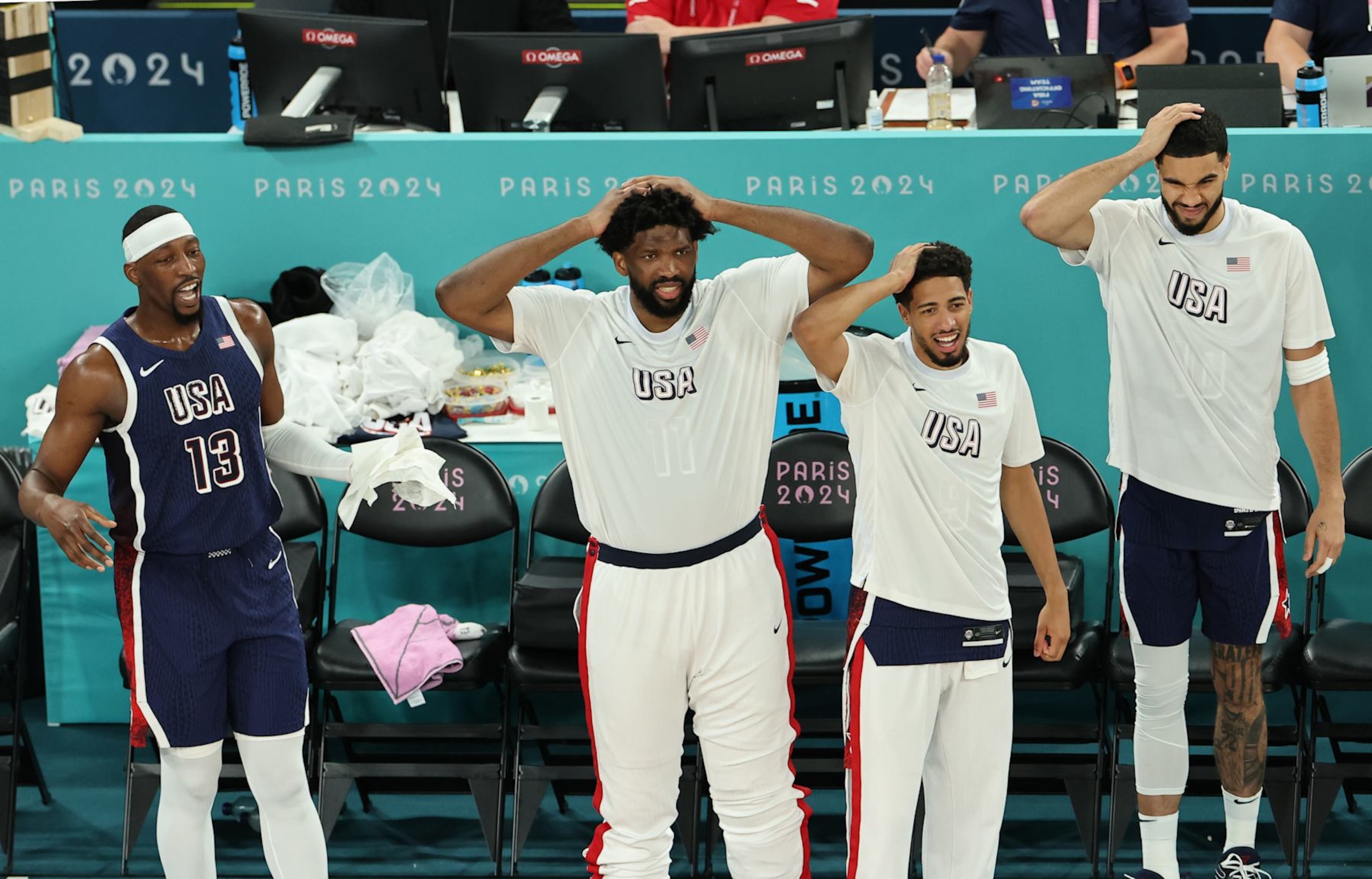 PARIS, FRANCE - AUGUST 06: Bam Adebayo #13, Joel Embiid #11, Tyrese Haliburton #9, and Jayson Tatum #10 of Team United States react from the bench during a Men's basketball quarterfinal game between Team United States and Team Brazil on day eleven of the Olympic Games Paris 2024 at Bercy Arena on August 06, 2024 in Paris, France. (Photo by Arturo Holmes/Getty Images)