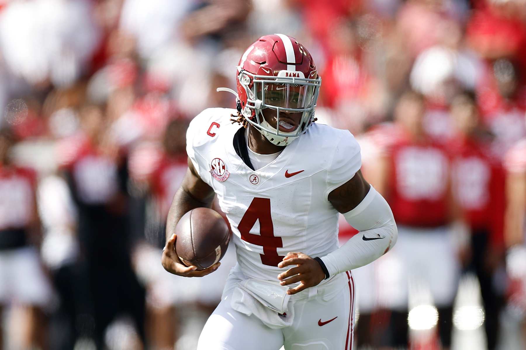 MADISON, WISCONSIN - SEPTEMBER 14: Jalen Milroe #4 of the Alabama Crimson Tide runs with the football during the game against the Wisconsin Badgers at Camp Randall Stadium on September 14, 2024 in Madison, Wisconsin. (Photo by John Fisher/Getty Images)