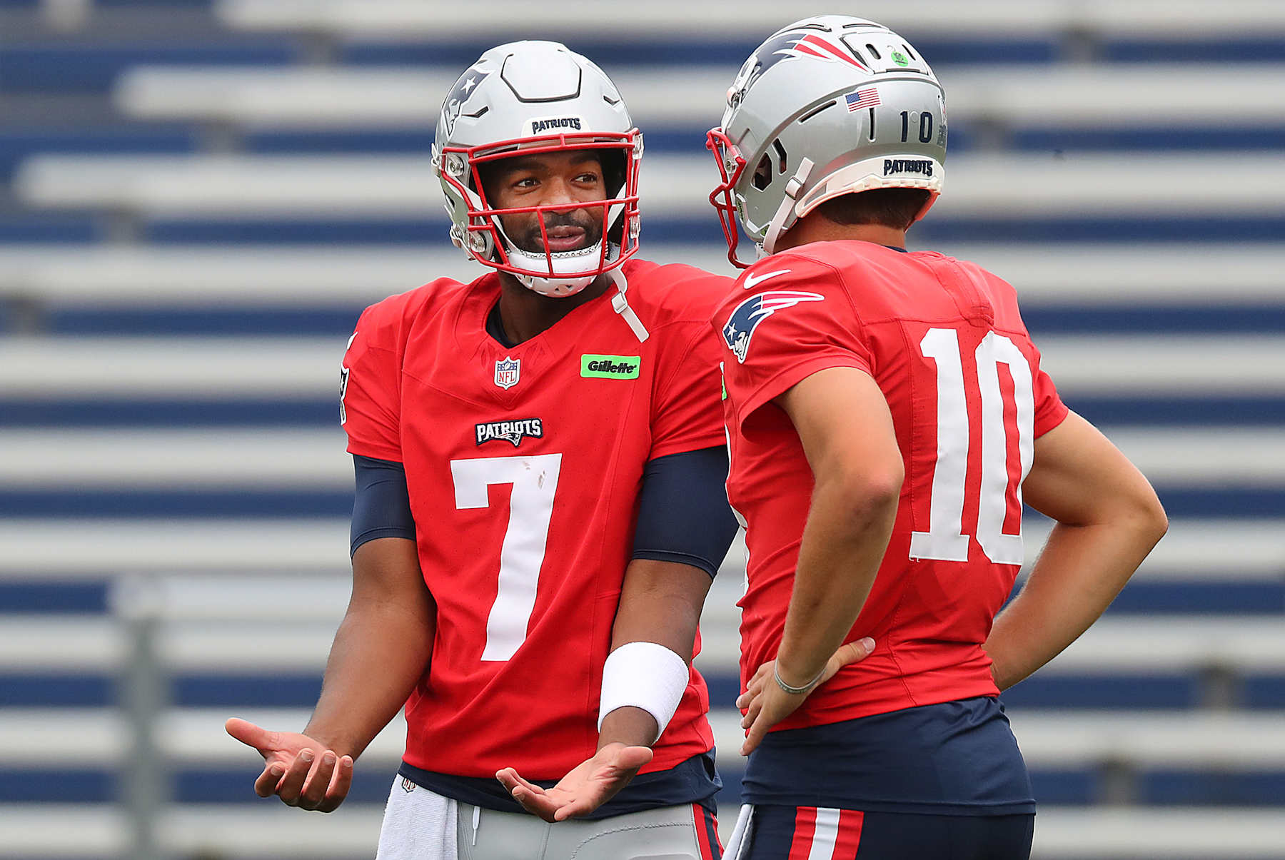 Foxborough, MA - September 25: New England Patriots QB Jacoby Brissett chats with Drake Maye during practice. (Photo by John Tlumacki/The Boston Globe via Getty Images)