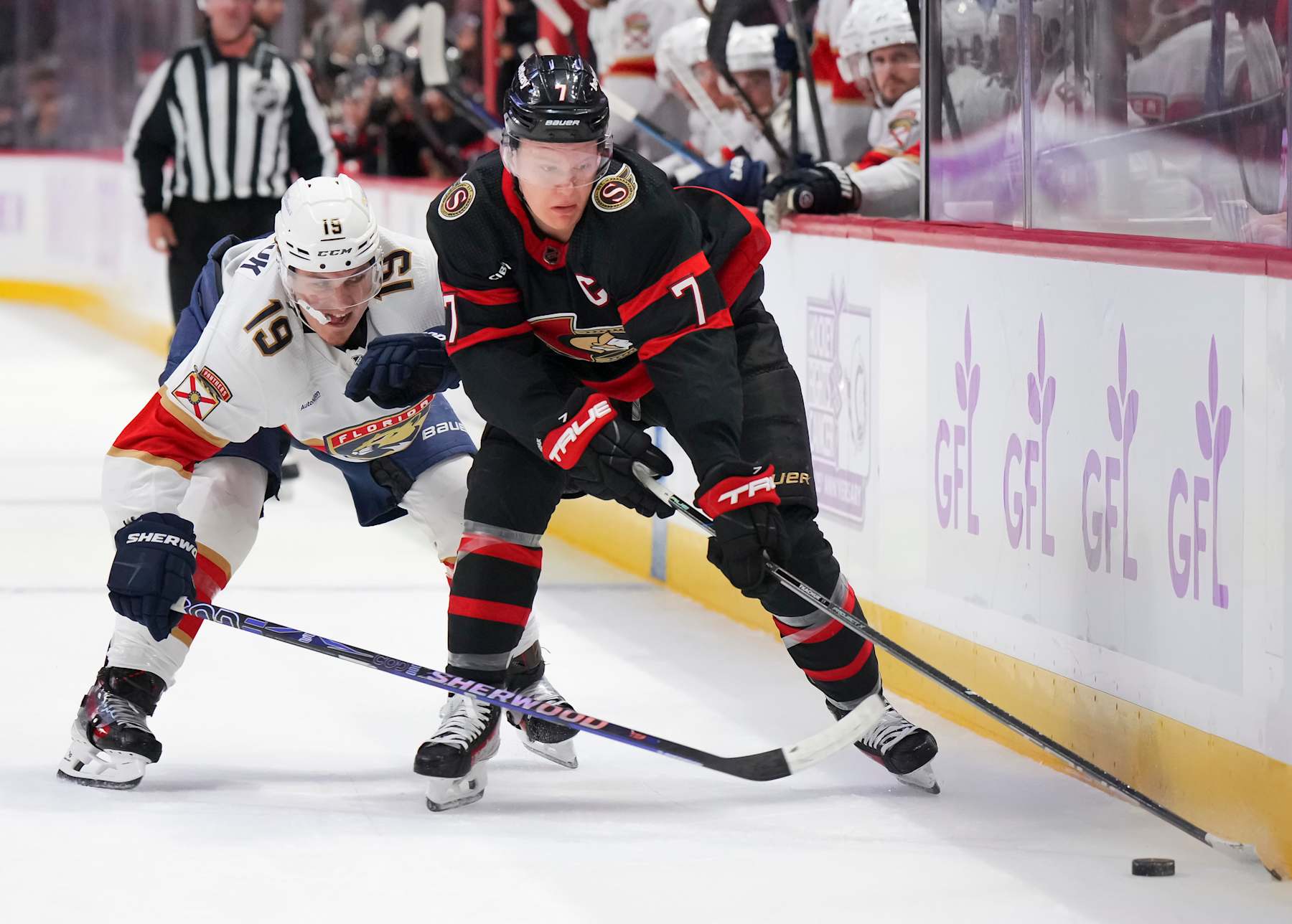OTTAWA, CANADA - NOVEMBER 27: Brady Tkachuk #7 of the Ottawa Senators battles for puck possession against Matthew Tkachuk #19 of the Florida Panthers at Canadian Tire Centre on November 27, 2023 in Ottawa, Ontario, Canada. (Photo by André Ringuette/NHLI via Getty Images)